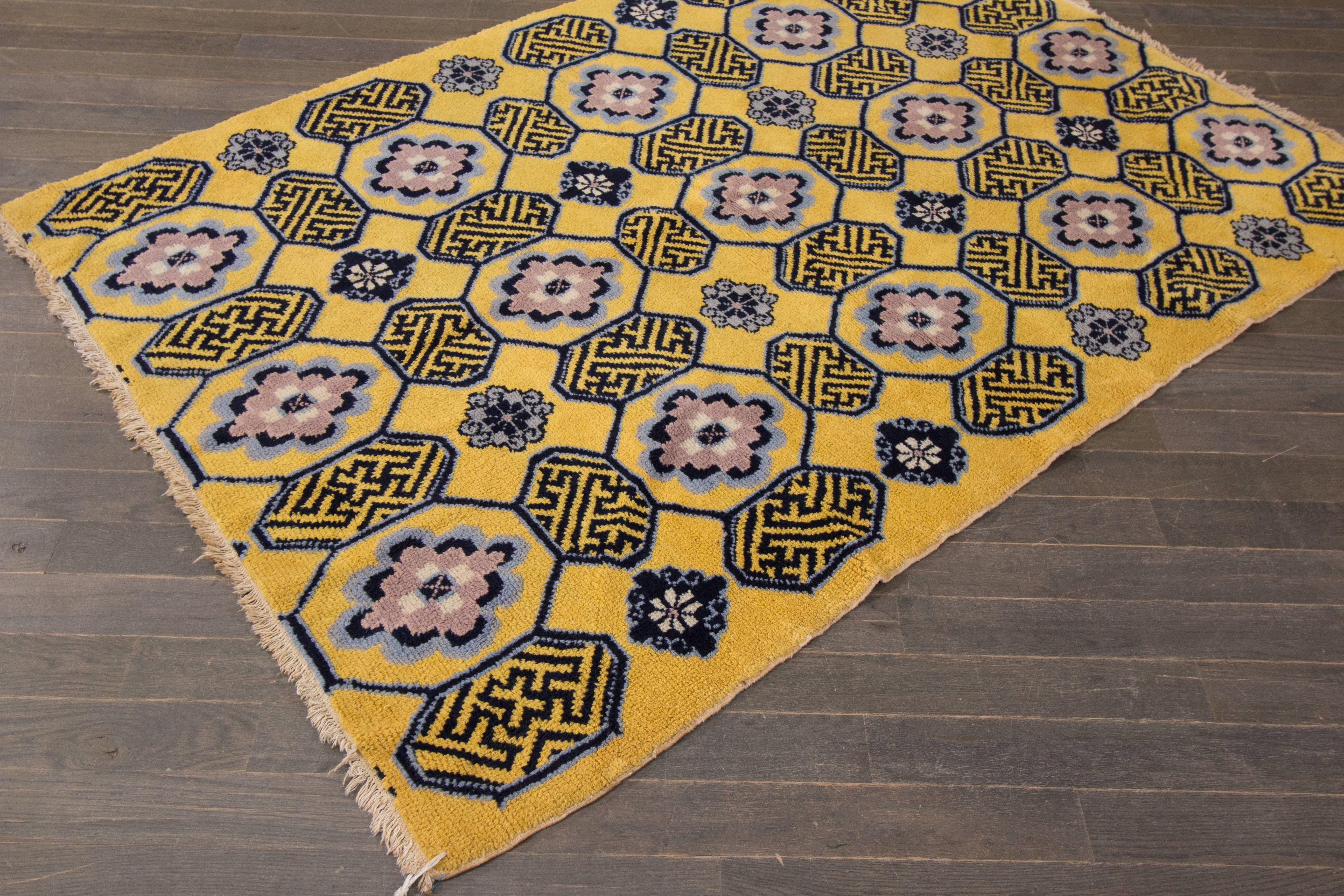 Vintage 1950s Chinese carpet with a mustard-yellow field and blue/gray geometric pattern throughout. Measures 4.05x6.04.