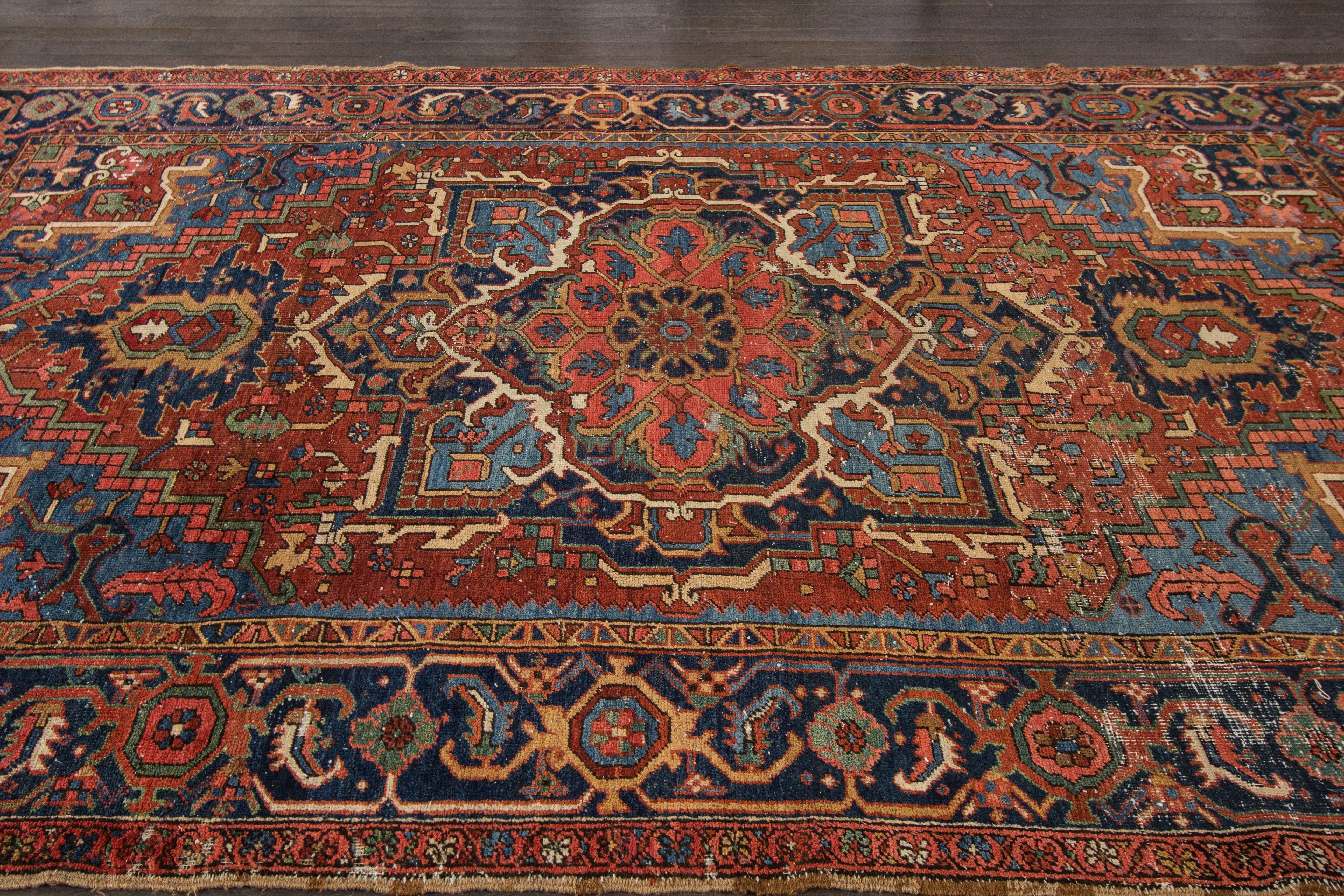 Measures: 7.3 x 9.8
A gorgeous one of a kind antique Heriz rug with a floral medallion design on a red field. Accents of blue, green, brown and ivory throughout the piece.