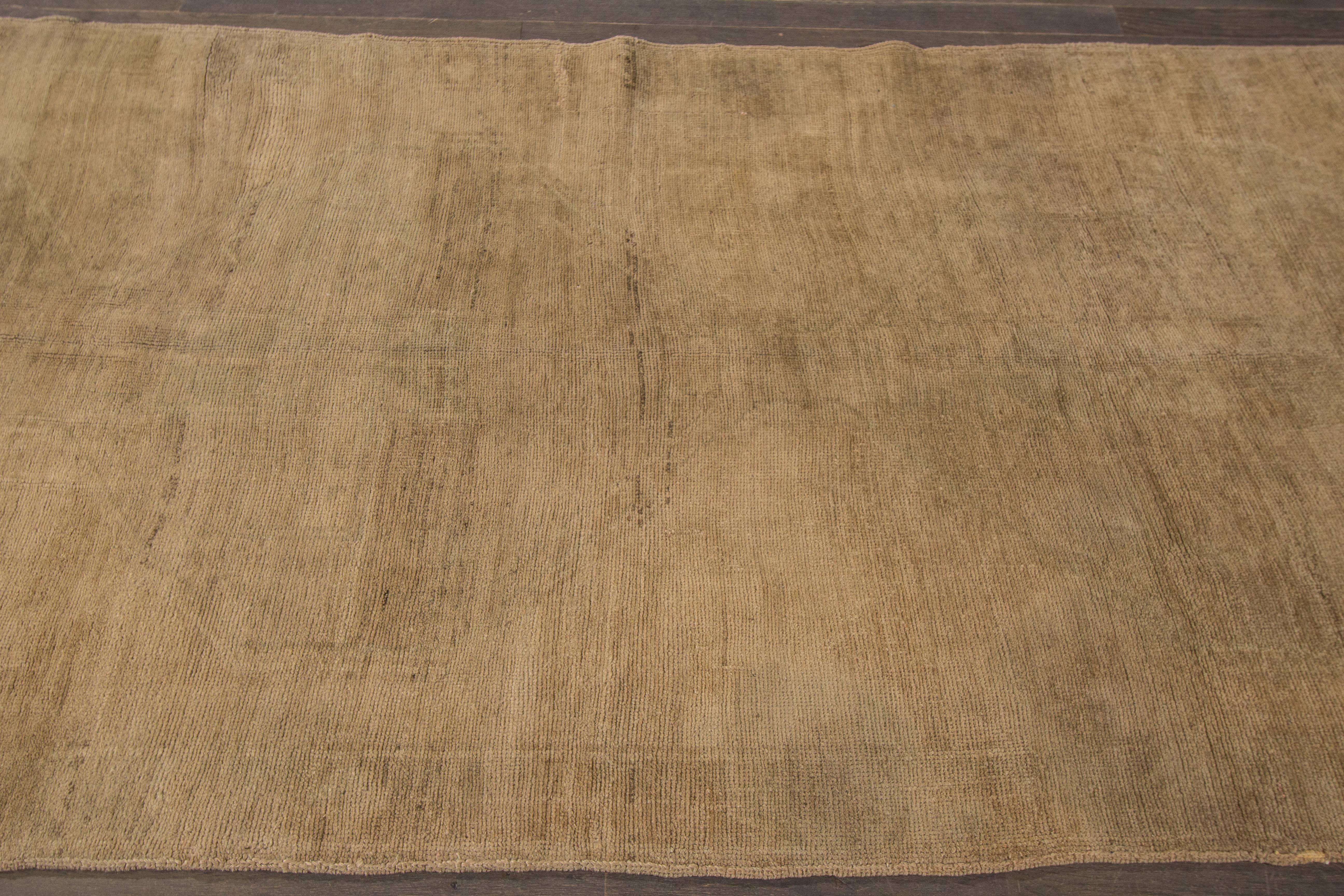 A hand-knotted antique Khotan rug with a subtle geometric design on a beige field. The size of this piece is 5' x 11'.7.