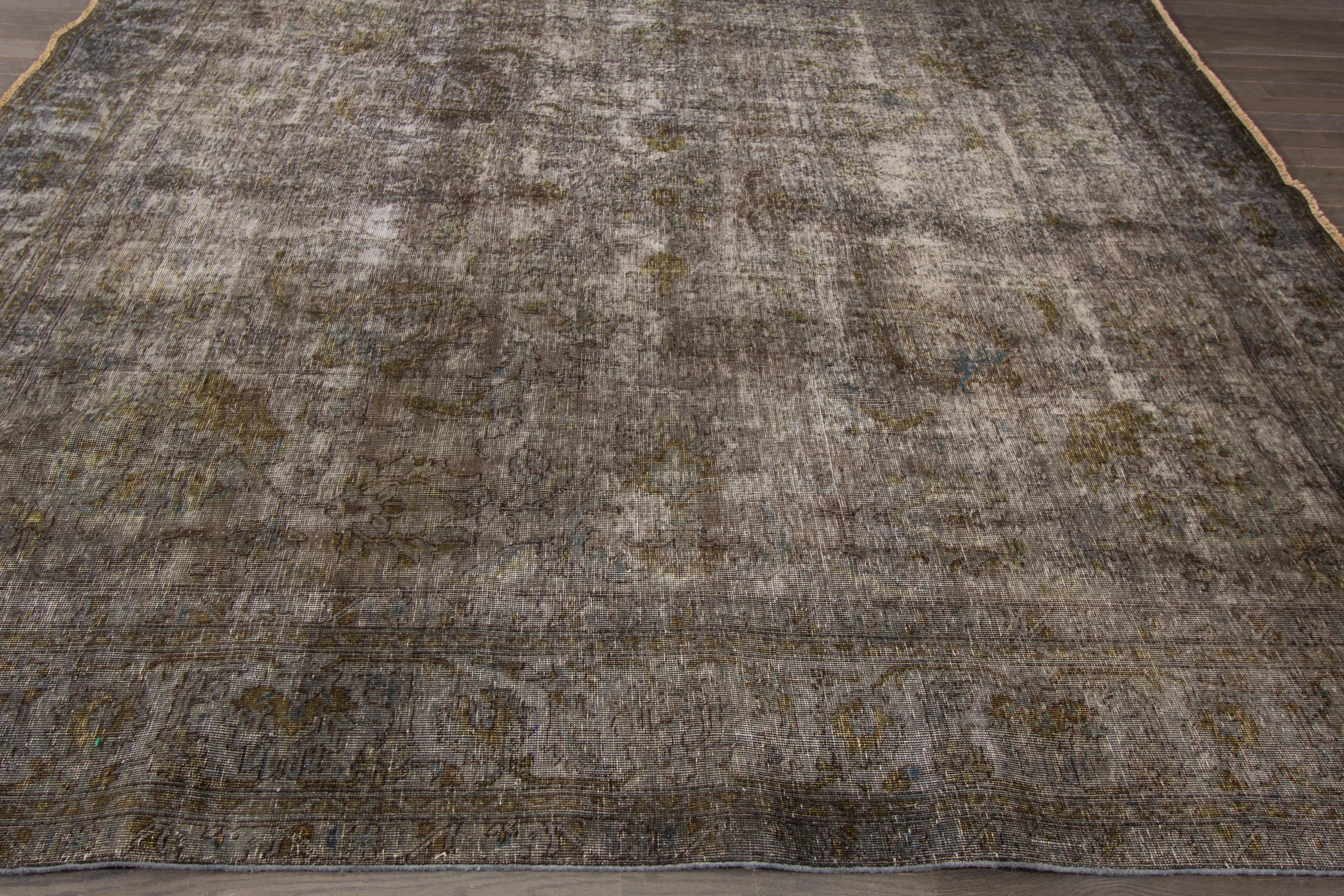 A hand-knotted square overdyed rug with an all-over design on a brown field. Accents of ivory and beige throughout the piece. This rug measures 9'.2 x 9'.3.