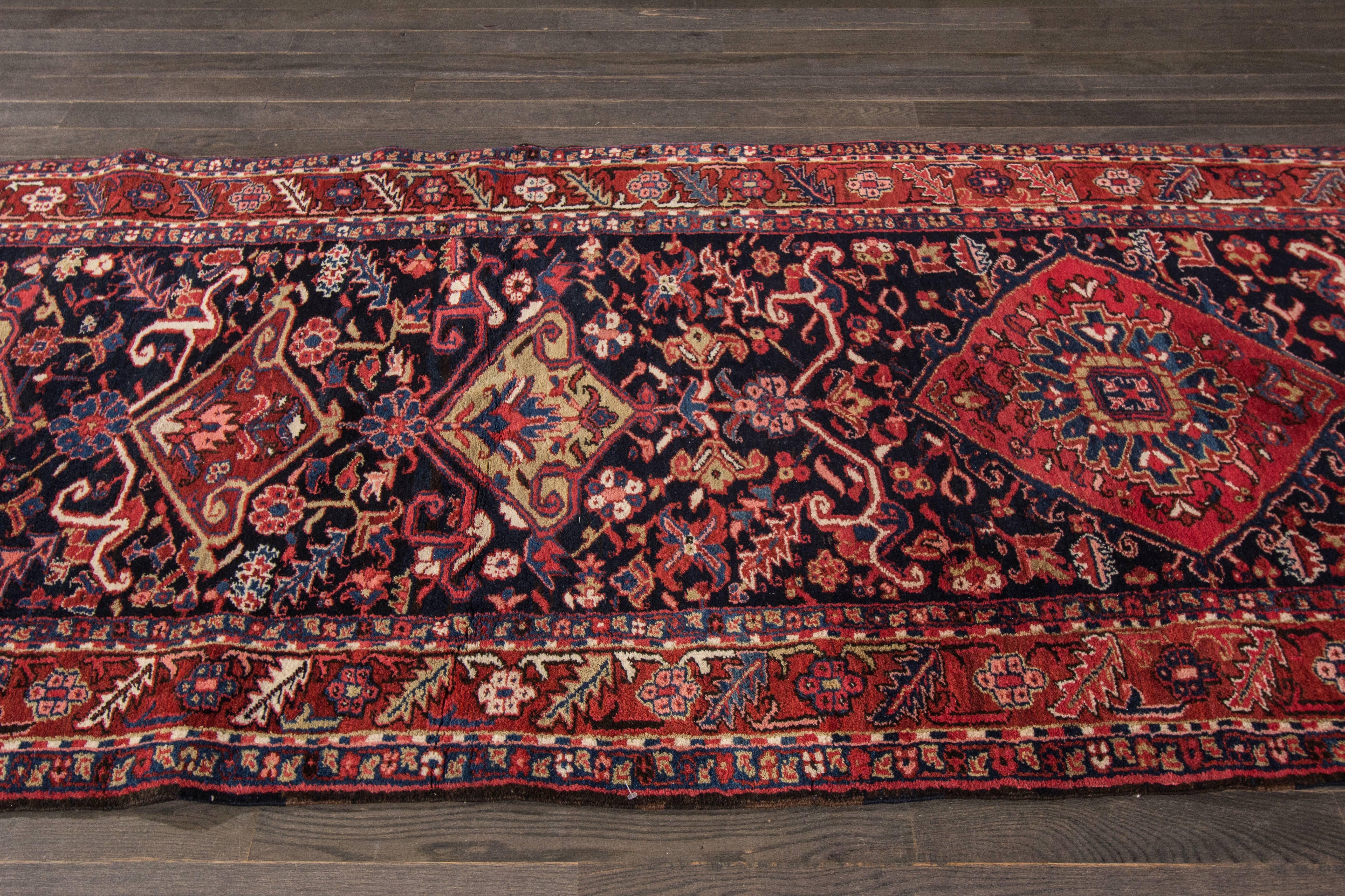 This beautiful vintage Persian Heriz hand-knotted rug . This rug is made in wool. It's measures are: 3'.11 x 13'.7. The origin of this vintage Persian Heriz Rug is Iran.