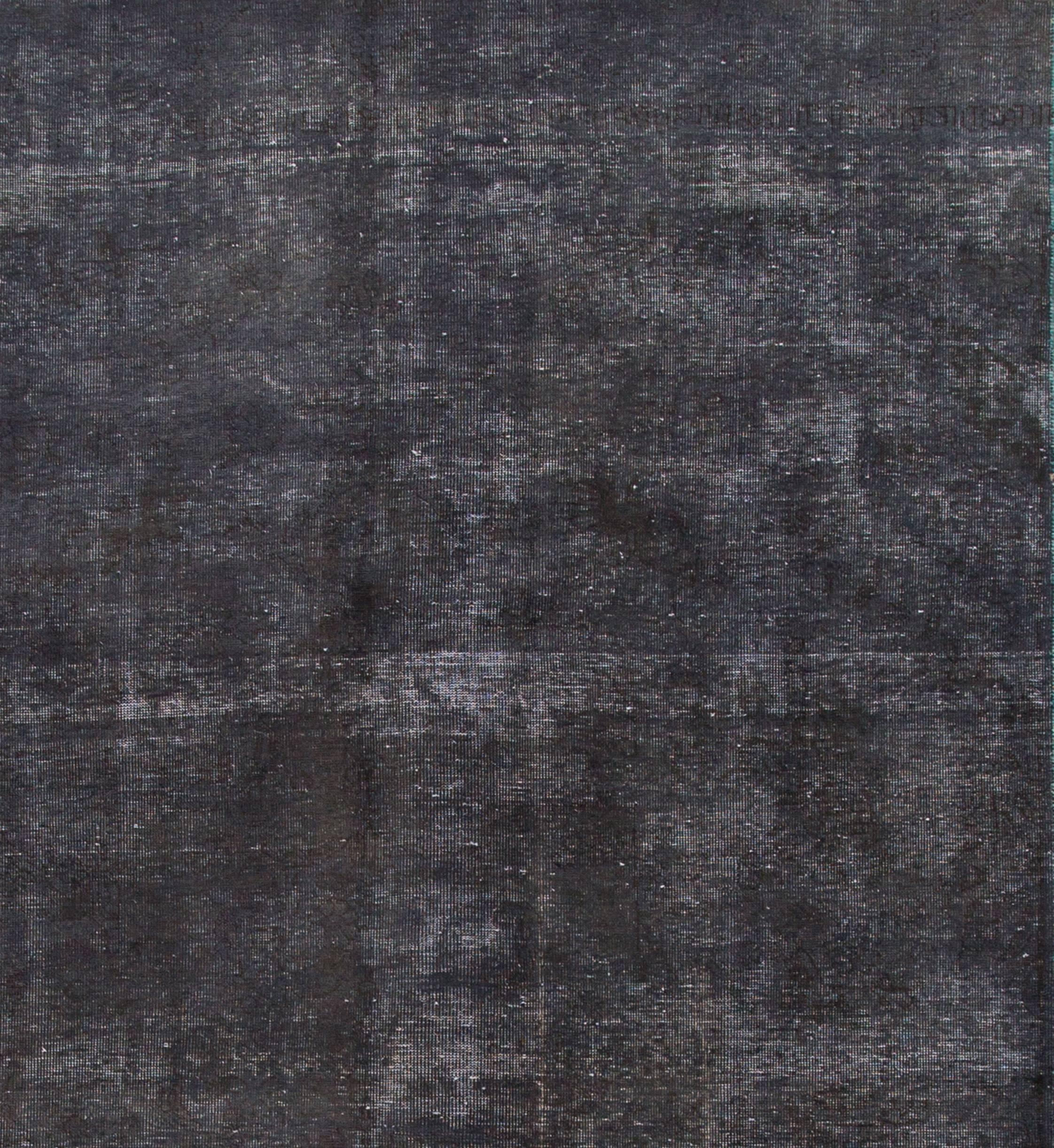 Vintage gallery size distressed overdyed carpet with dark blue/gray field and floral design, measure: 7 x 11.09.