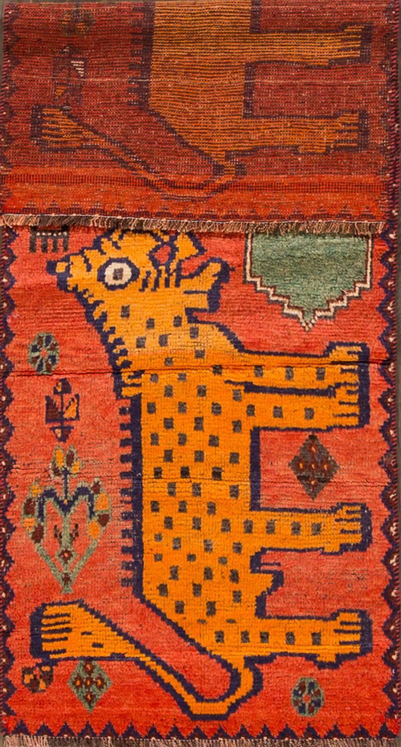Vintage 1960s Persian Gabbeh carpet with an orange field, pictorial design (lions/tigers). Measures: 2.10 x 7.04.