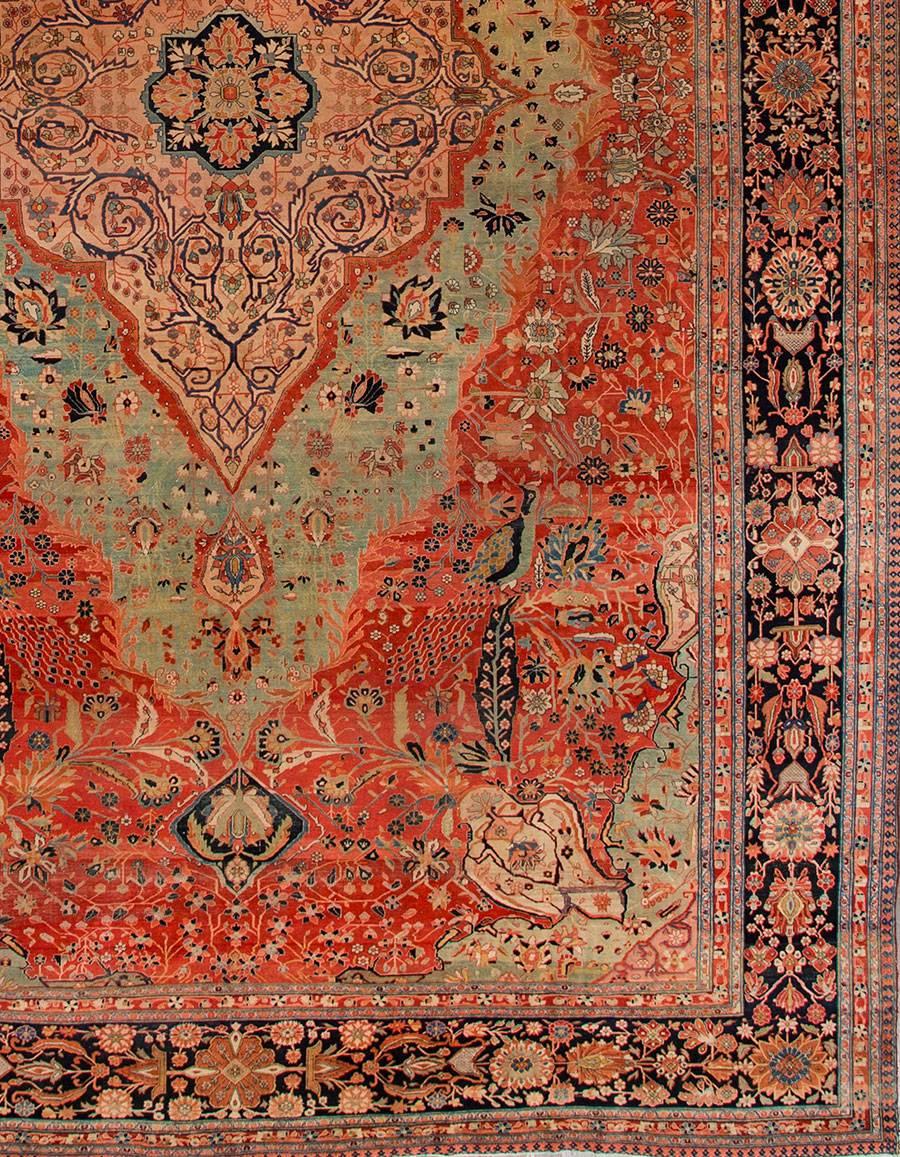 Early 19th. century Persian Kashan carpet with a rust field, teal and blue accents and a traditional medallion design. Measures: 10.09 x 17.01.