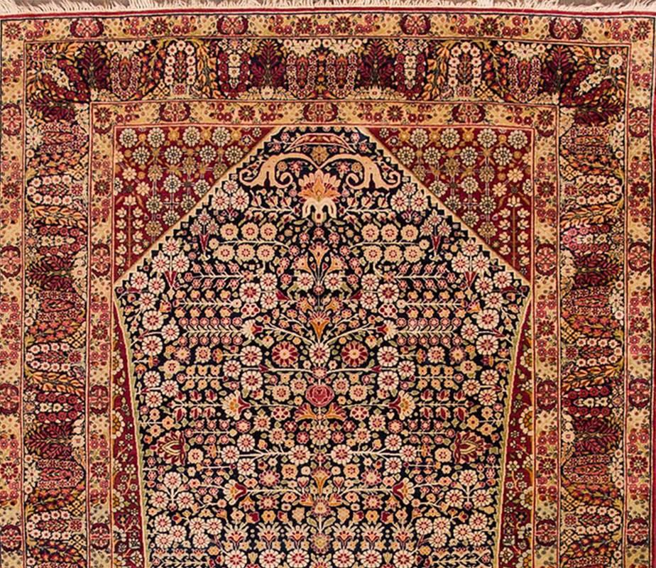 Early 20th century Persian Kerman carpet with a rust field, salmon pink and blue accents and a traditional design. Measures: 4.05 x 7.02.