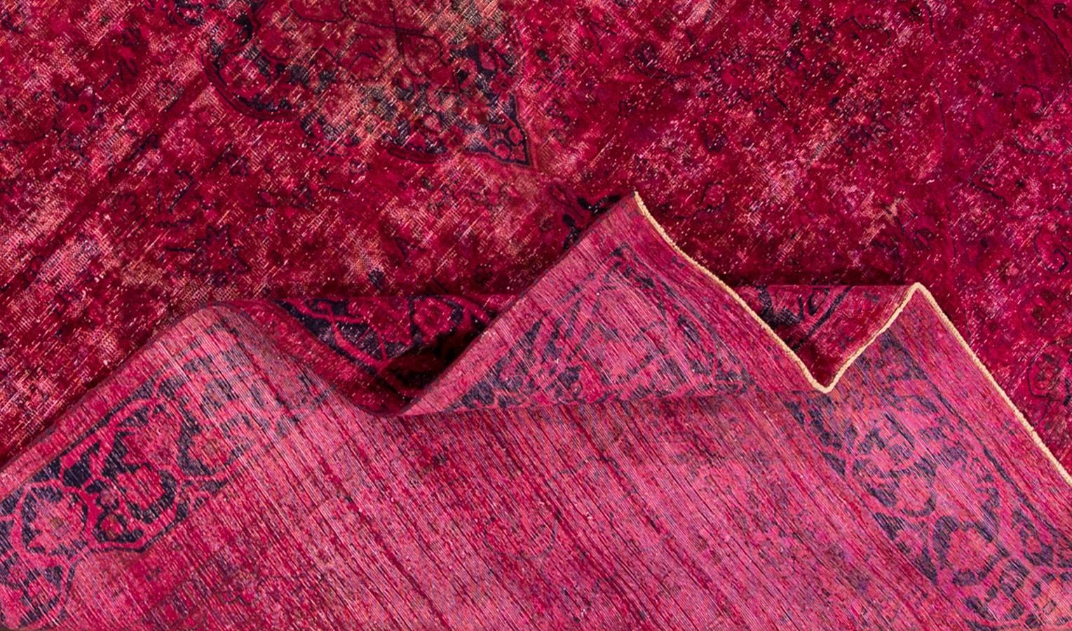 Vintage 1945 Persian overdyed rug. This piece has a field that was dyed bright pink, and has a visible border details and a medallion in the centre. Measures 9.01 x 12.06.