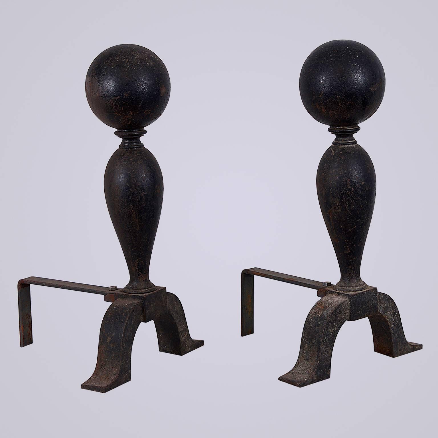 Early 20th century, Colonial style, cast iron cannonball andirons. Replacement log supports have been added to the back.
