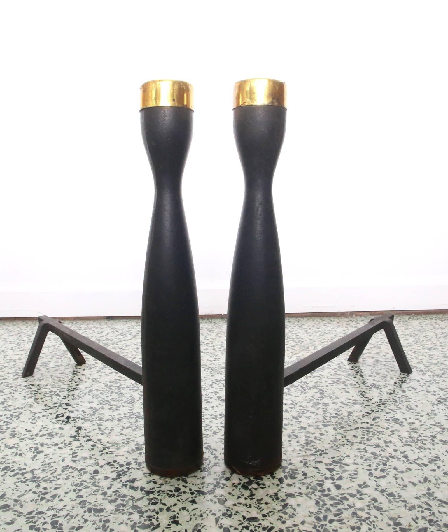 Very nice pair of modernist andirons with brass cap tops. Heavy black metal base.