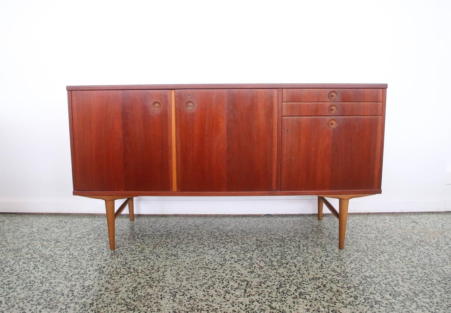 Very sleek Mid-Century Modern Swedish credenza by Abra Mobler. Doors open to reveal shelving.