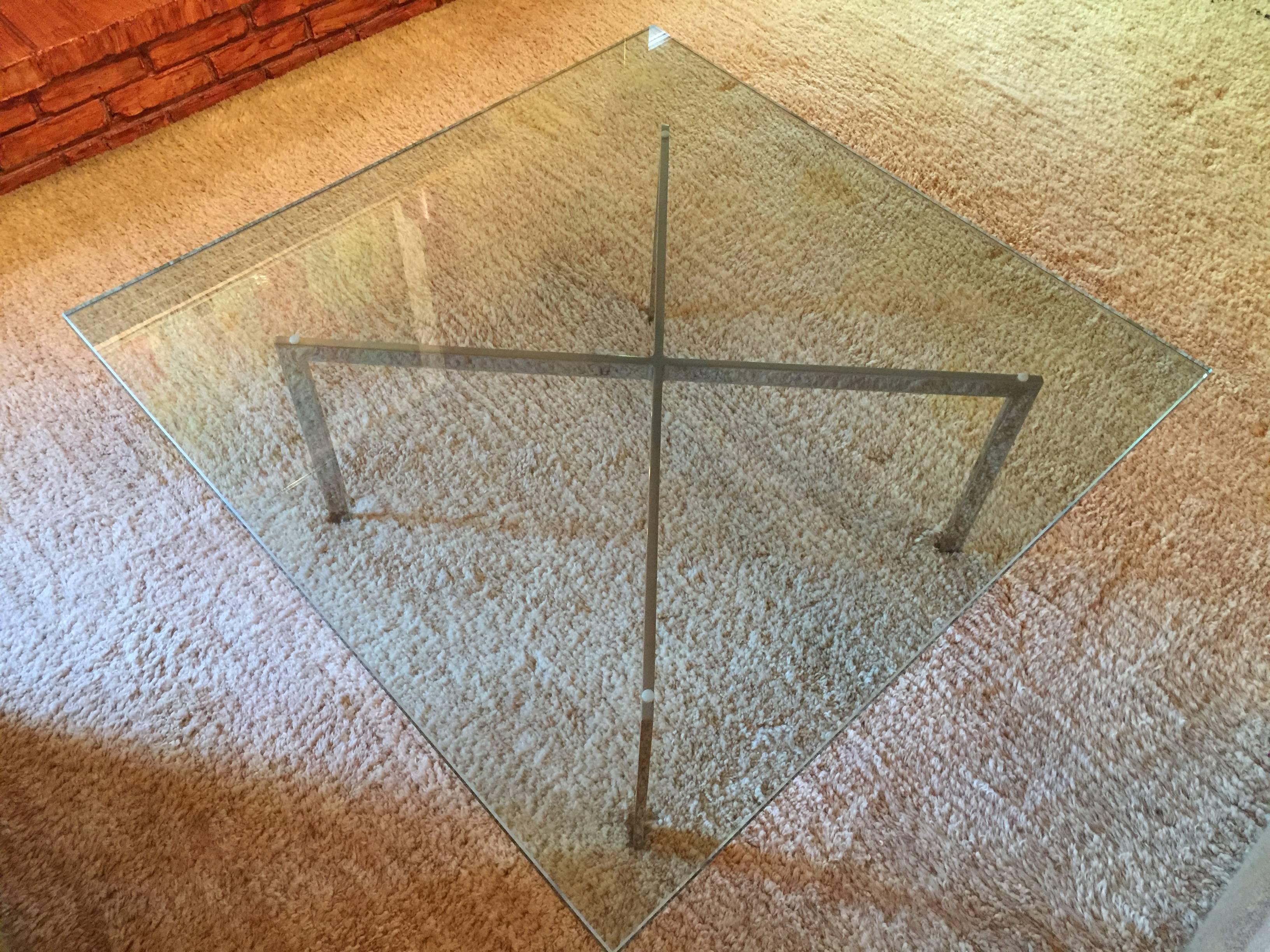 Classic Mid-Century iconic design. Mies van der Rohe for Knoll coffee table. Stainless steel and glass top. 