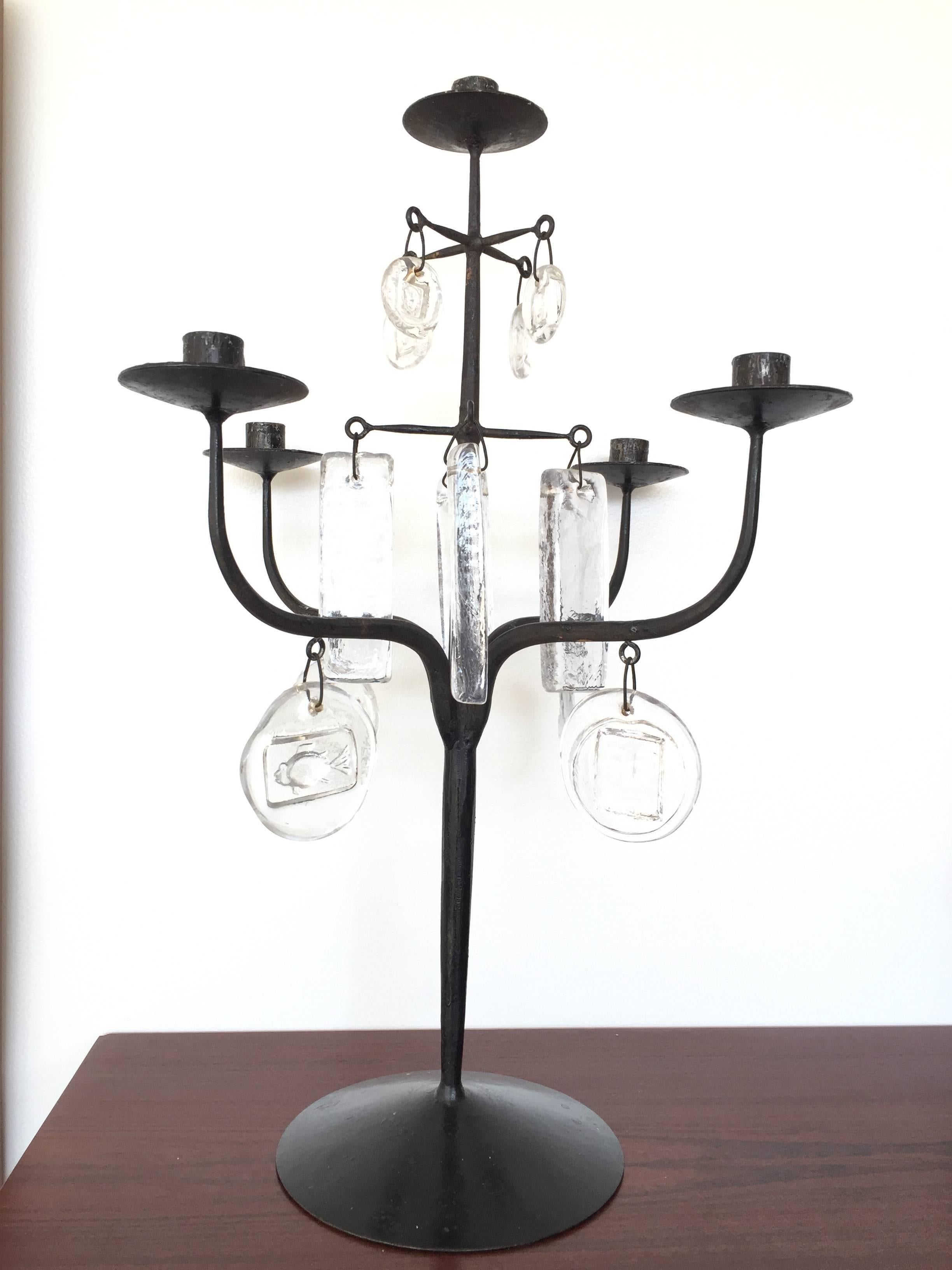 Very tall and heavy black iron candelabra candleholder by Erik Ho¨glund with various clear glass discs with impressed images, Designed in 1957 for Boda Glassworks. Ironwork by Axel Stro¨mberg.