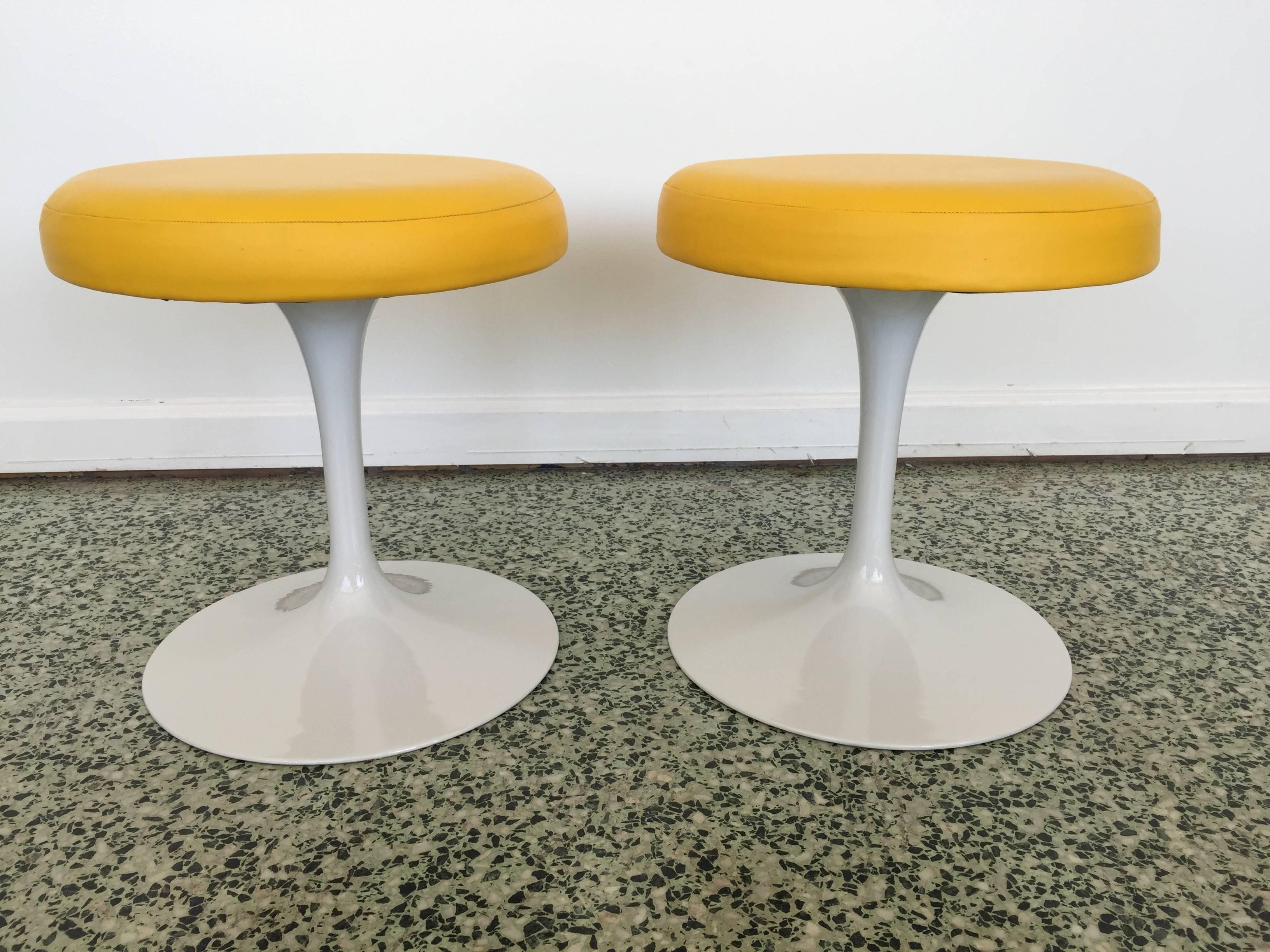 Saarinen for Knoll stools with newer upholstery and paint. Bright yellow leather.