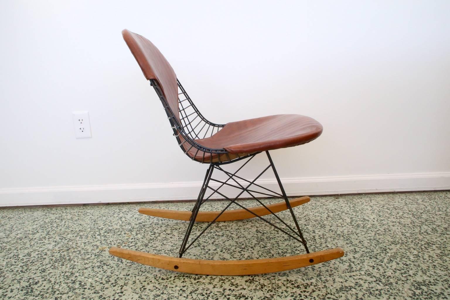 Eames wire rocking chair with birch runners and brown Naugahyde cover. This is an excellent example. We have four matching dowel base Eames chairs in separate listing.