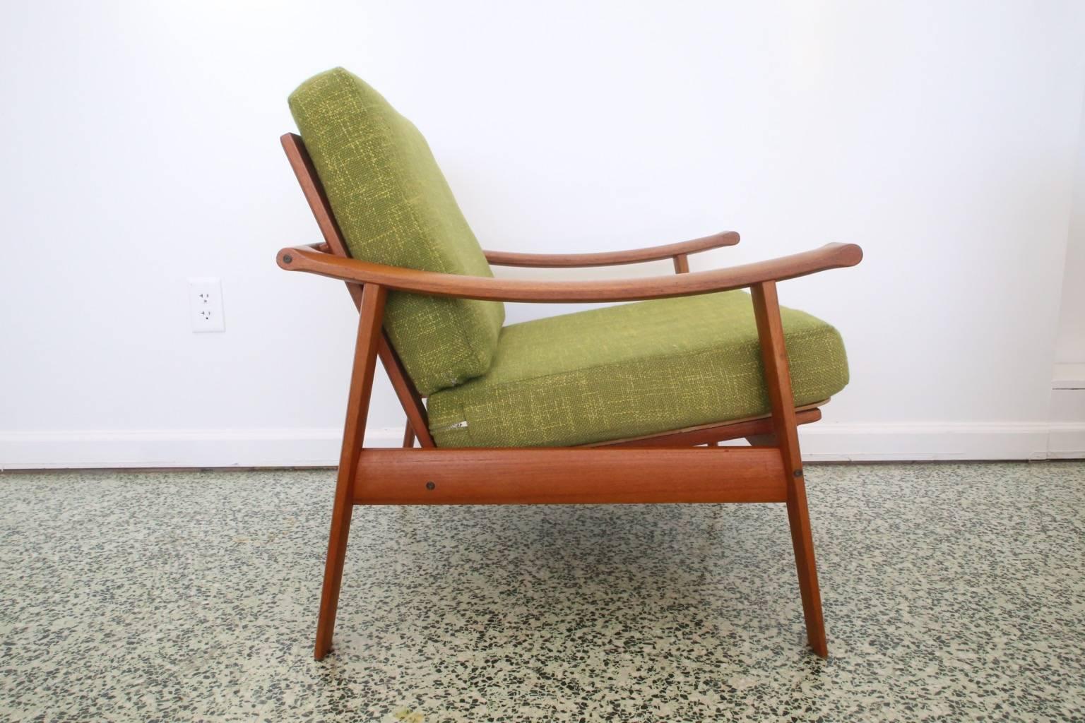 Arne Wahl Iversen lounge chair with teak frame, over-extended arms and deep seat. Original upholstery.