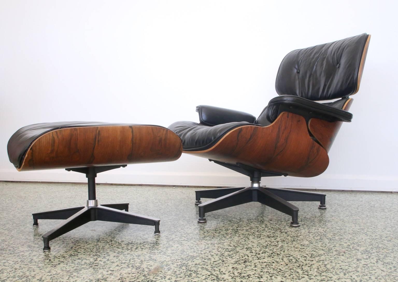 Herman Miller Eames rosewood 670/671 lounge chair and ottoman. Original leather upholstery and down/duck filled cushions. Three hole screw pattern on the armrests and boot glides which point to the very earliest production. Minor leather crackling