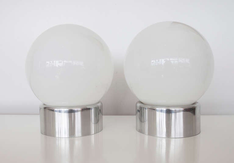 Beautiful pair of Lightolier globe lamps. Chrome bases with white glass globes. Adds a stunning glow to any room.