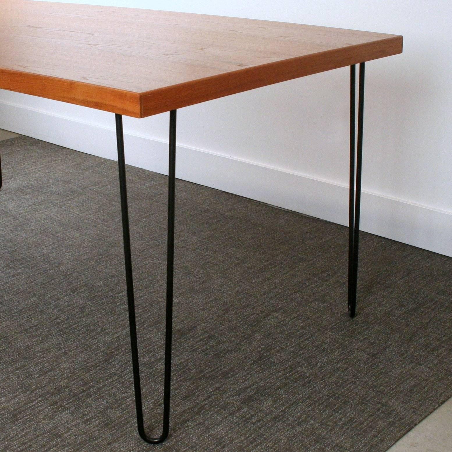 Repurposed teak tabletop set on four hairpin black metal legs. A perfect mix of vintage and modern for that Mid-Century Modern dining space. Very sleek and beautiful design. Made in Denmark.