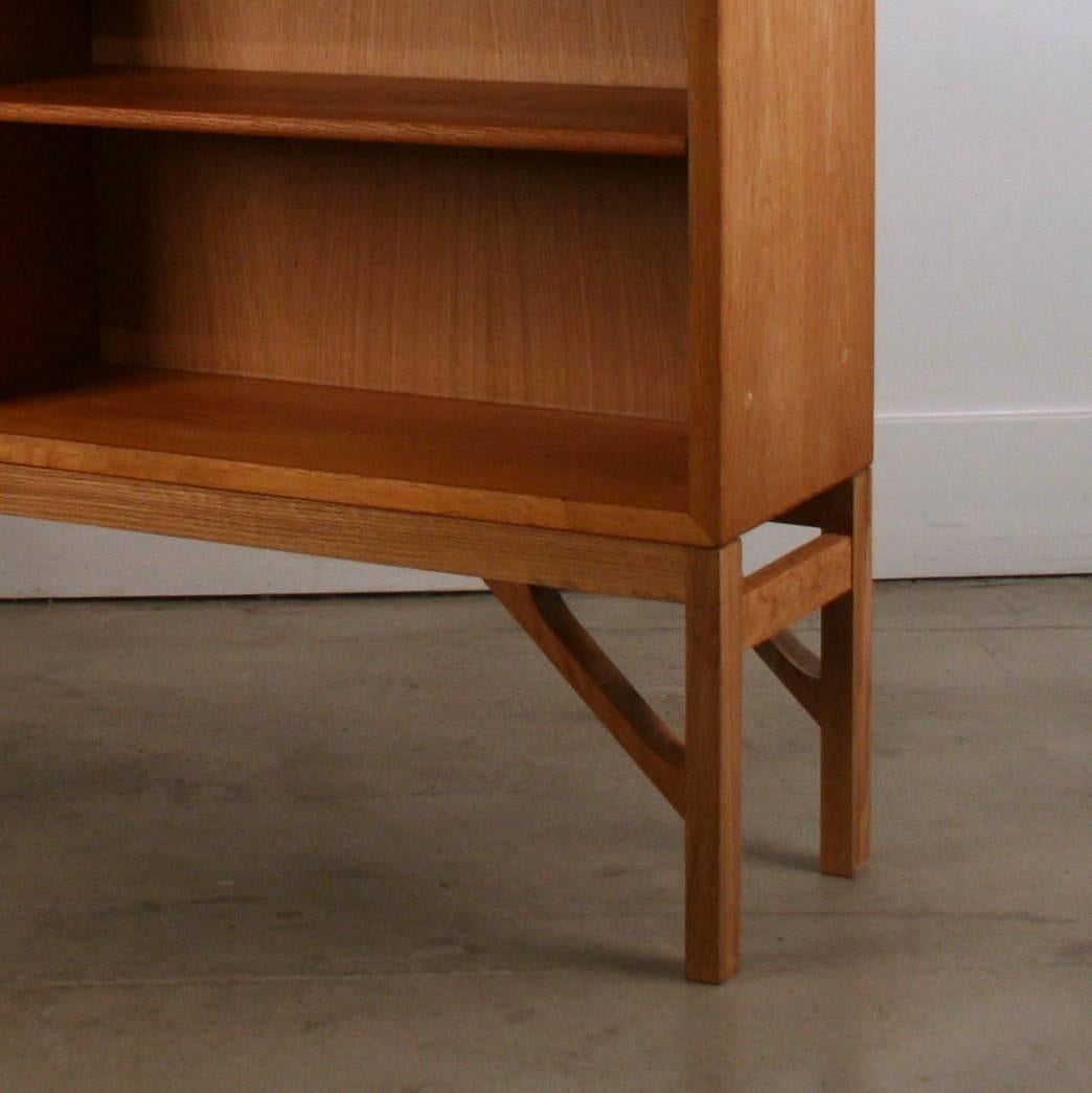 Low and wide vintage oak bookcase by Borge Mogensen. Adjustable shelves with beveled edge. Resting on solid oak legs. Made in Denmark.