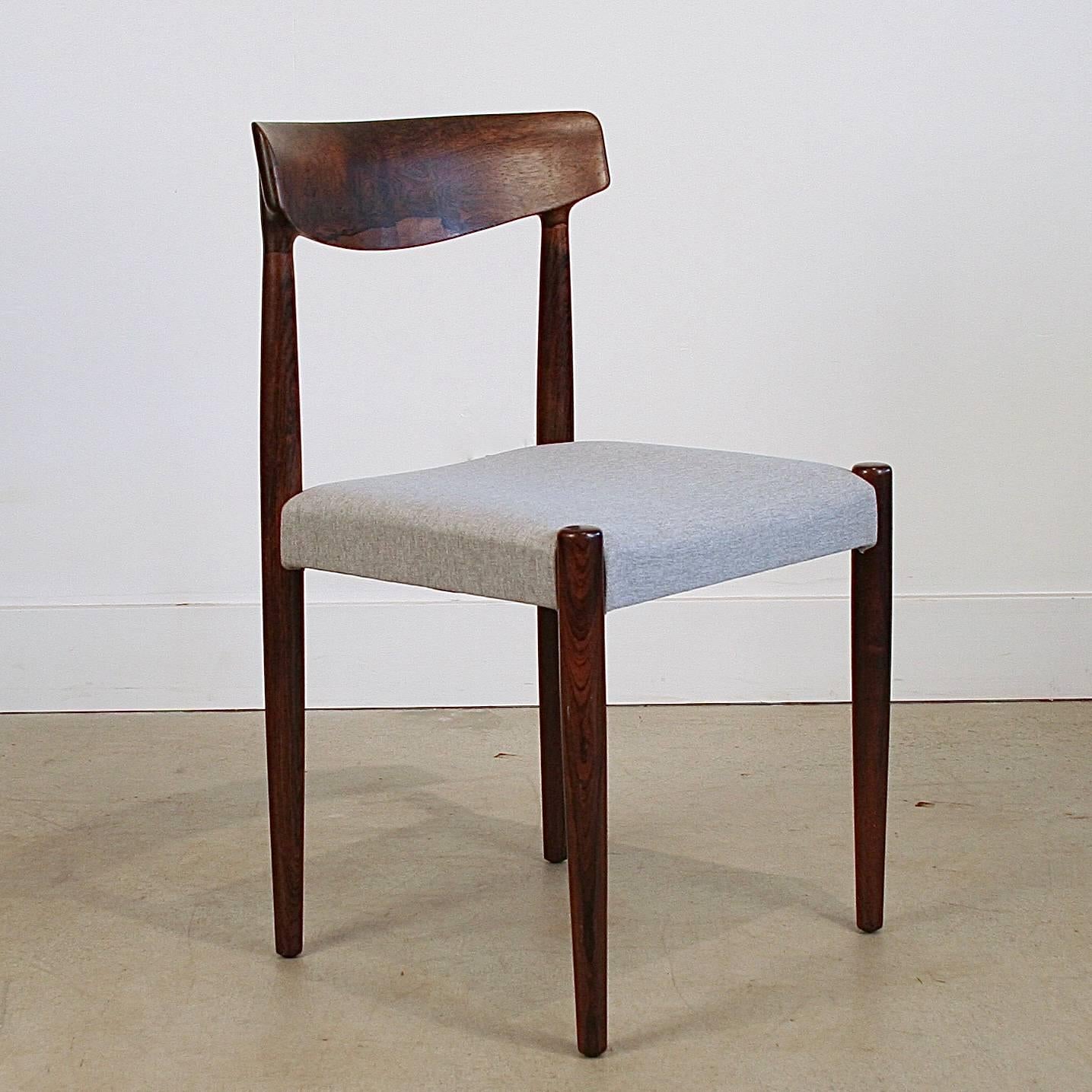 Exquisite vintage Danish rosewood dining chairs designed by Knud Faerch, Model 343. Newly reupholstered in a light grey fabric. Made in Denmark.