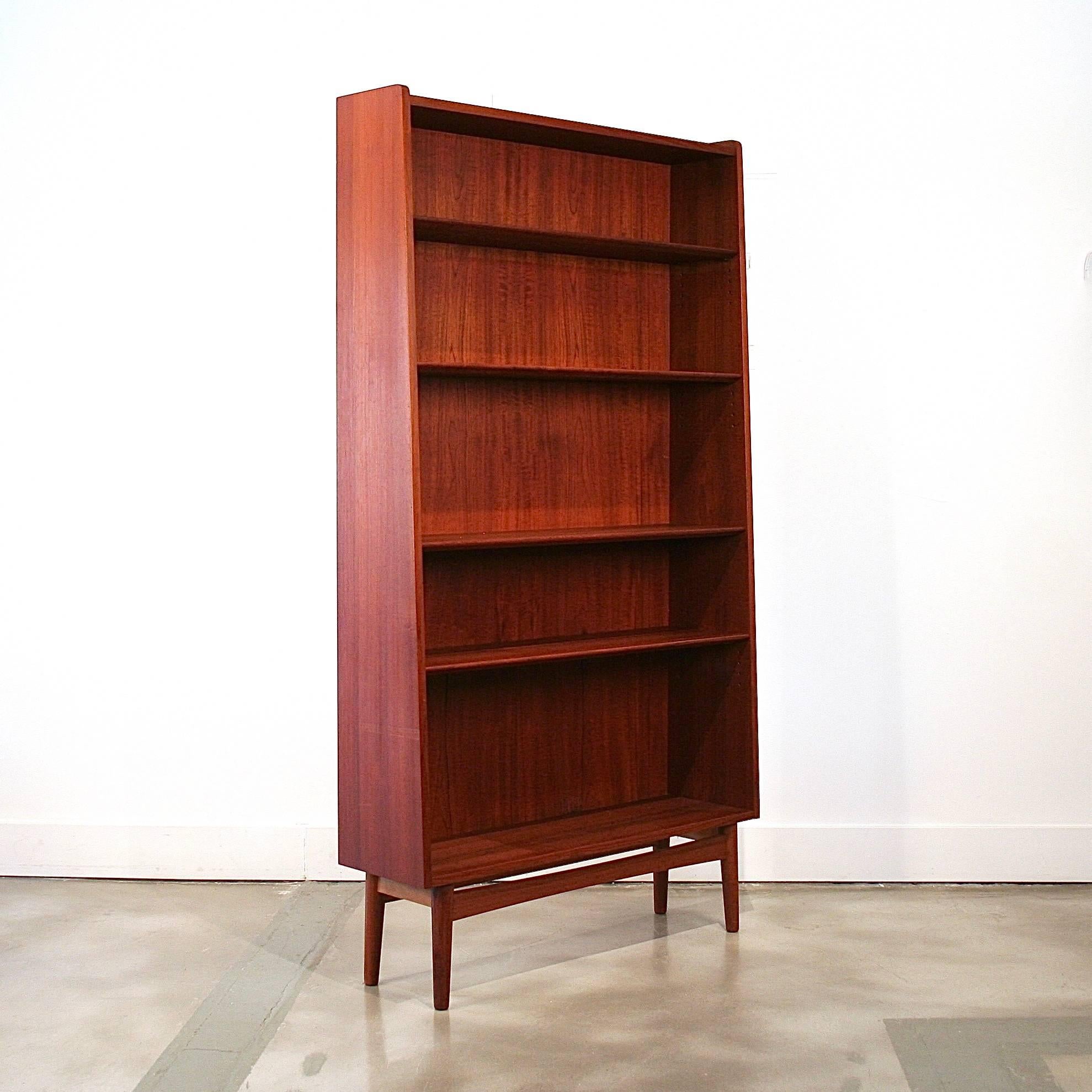 Wonderful tall vintage Danish teak bookcase with adjustable shelves and tapered sides. Made in Denmark.
