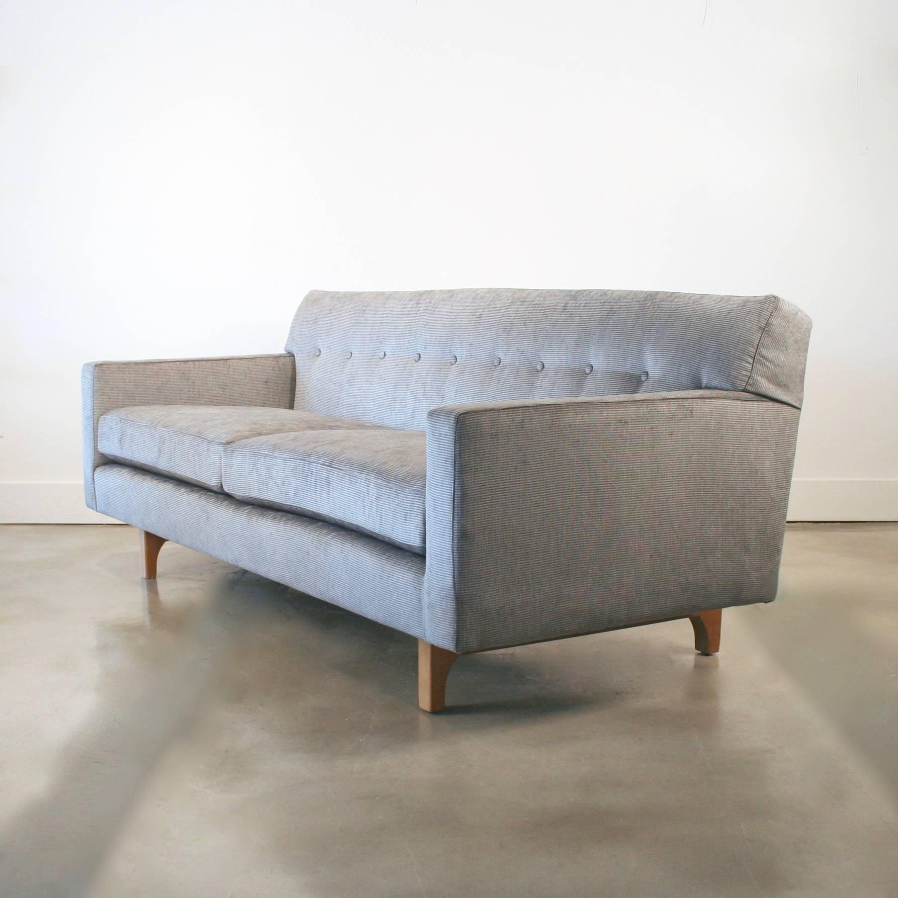 The Classic Dunbar sofa with button tufted back. It sits atop a gorgeous cradle frame that looks good from all angles. This beauty has all the charm of a retro piece plus the benefits of modern construction. Eco-friendly, down wrapped cushions,