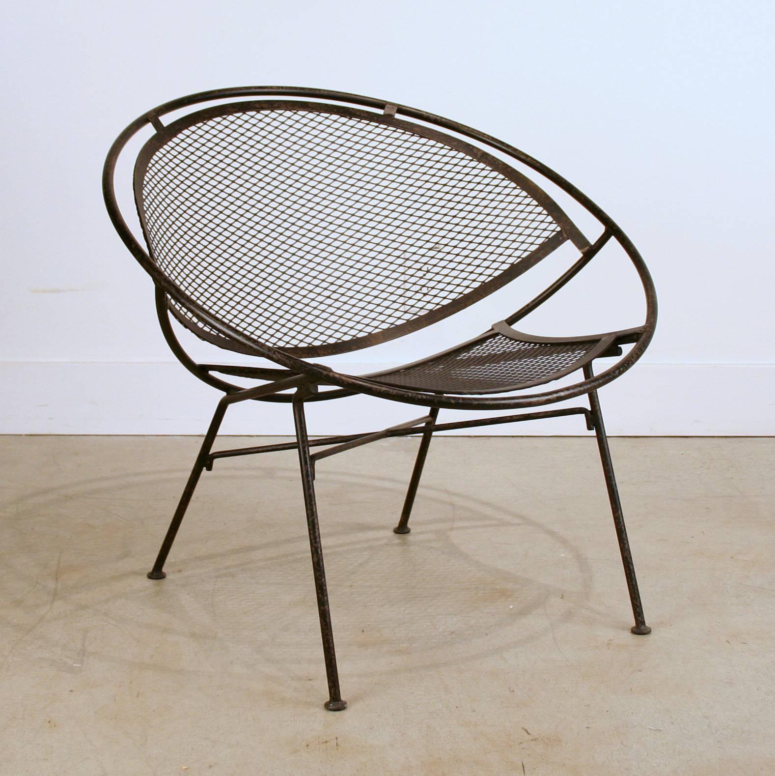 Inspired by Maurizio Tempestini for John Salterini's 1960s wrought iron patio furniture collection called the "Radar" this modern chair has strong Art Deco influences. Finished in an antiqued black or white. Indoor use only.