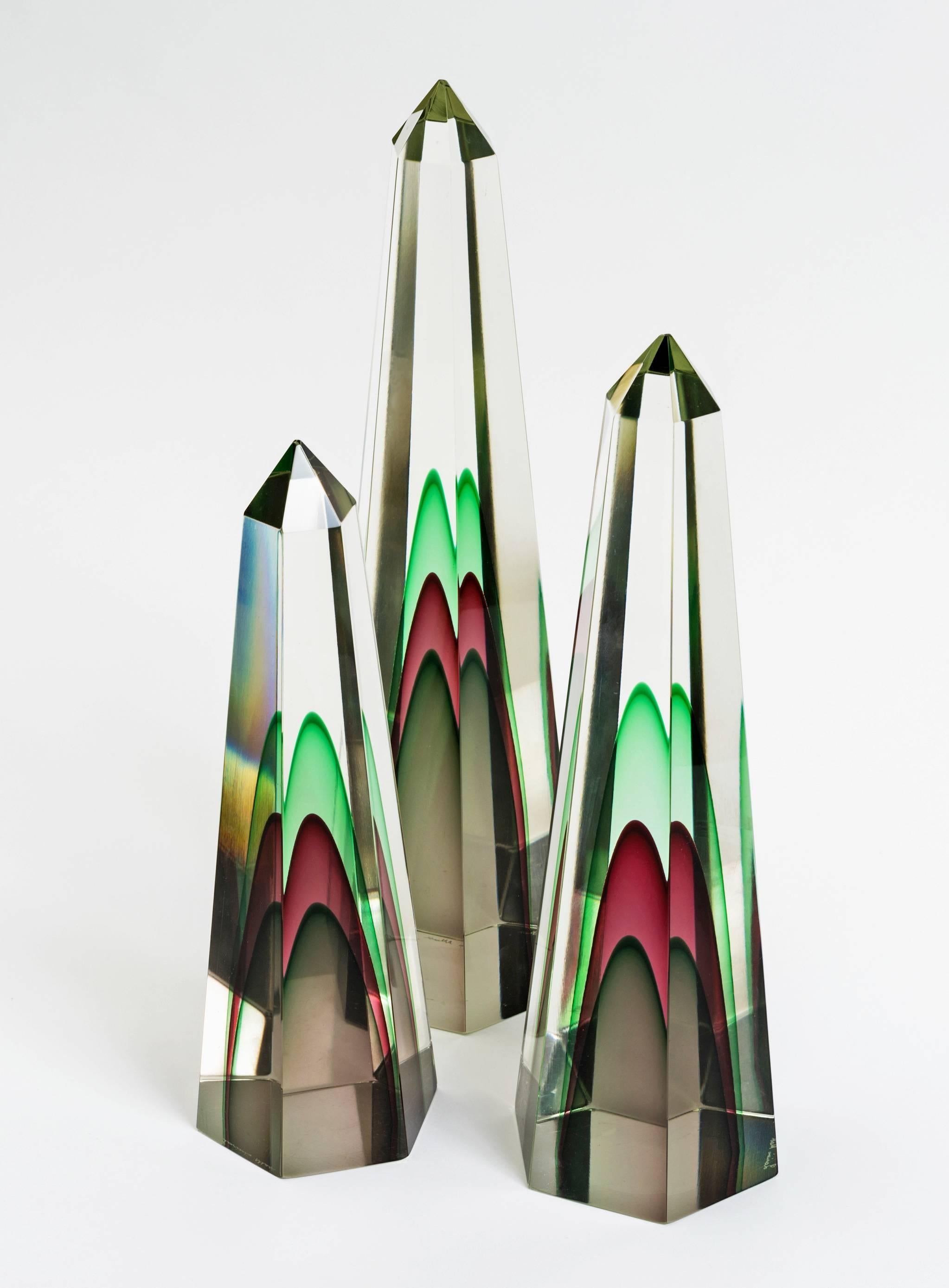 Stunning set of three Seguso Murano clear obelisks with green, maroon and topaz uranium. Color and design vary as angles change and the set of three graduating sizes presents beautifully with great scale and weight. Signed by the artist. Most likely