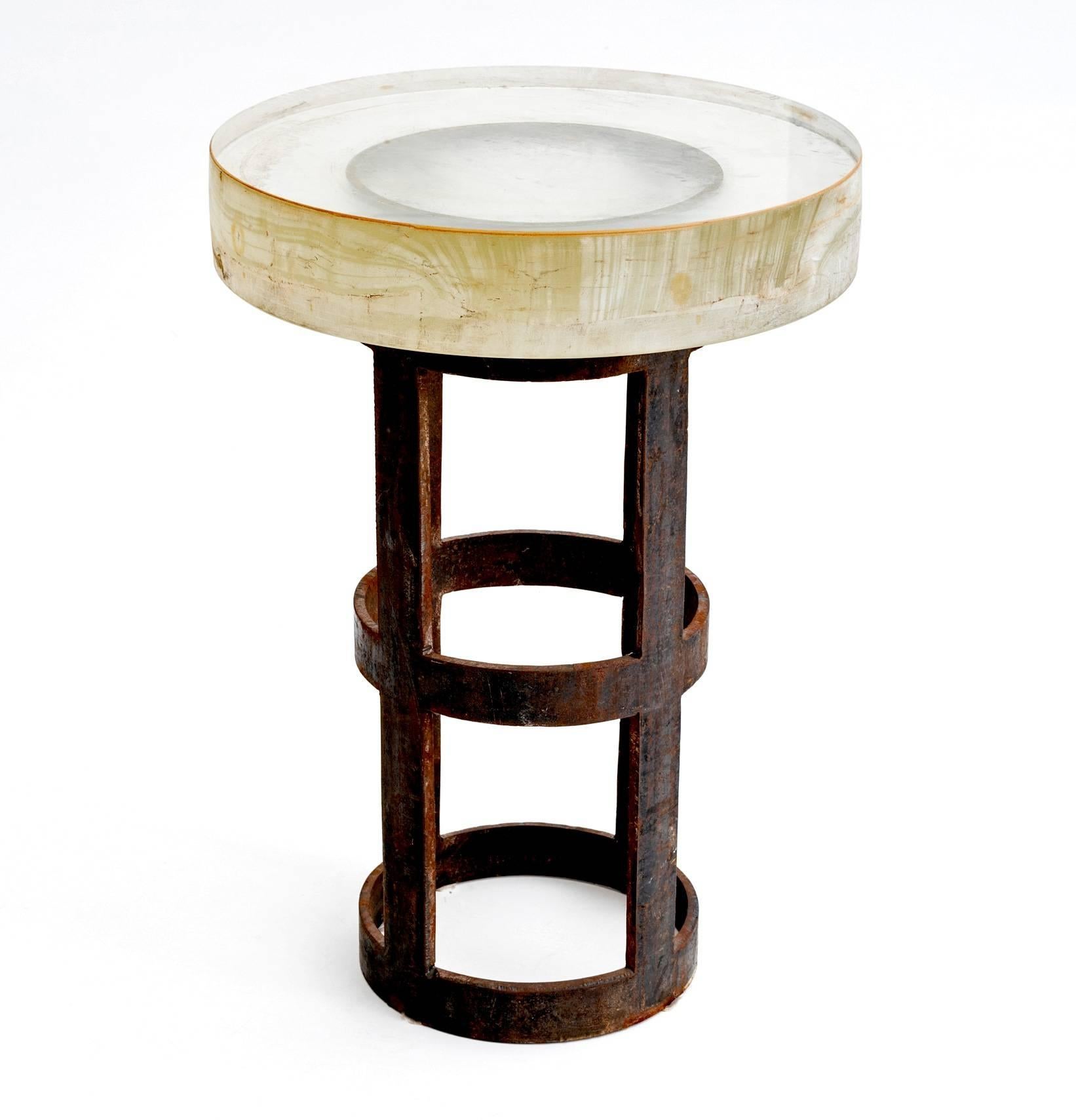 Super cool and chunky telescope lens table found on a black iron Industrial base. Top is super thick optical glass at three and half inches with a great distressed look. Rare and fabulous side table.  Attributed as optical glass for the Hubble