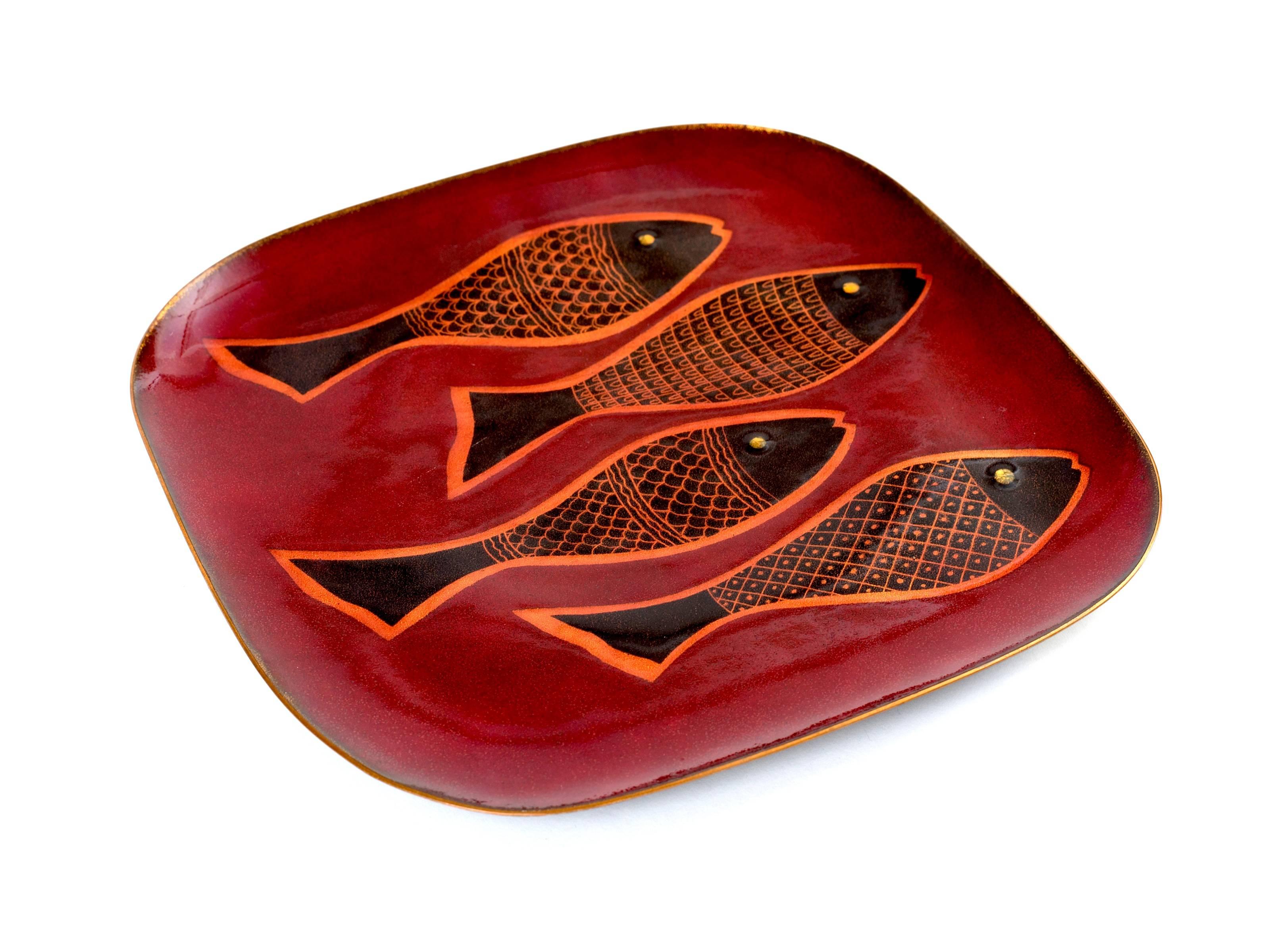 A striking and fabulous piece of Mid-Century Mexican Folk Art by Miguel Pineda in beautiful vintage condition. Four fishes on a background of vibrant colors of maroon, orange and black edged in gold. Miguel Pineda is internationally known for his