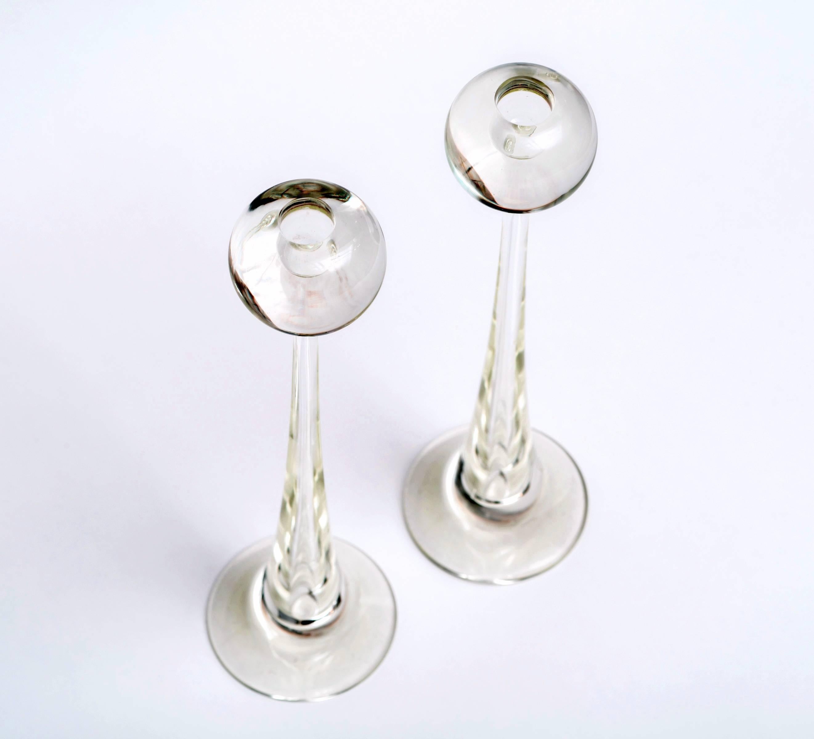 Fabulous pair of Murano clear glass ball candlesticks by Cenedese. This extra tall size is perfect for mixing with other candlesticks and are very unique with the large chunky ball top flairing into a round bottom. Great scale!

Note the glass