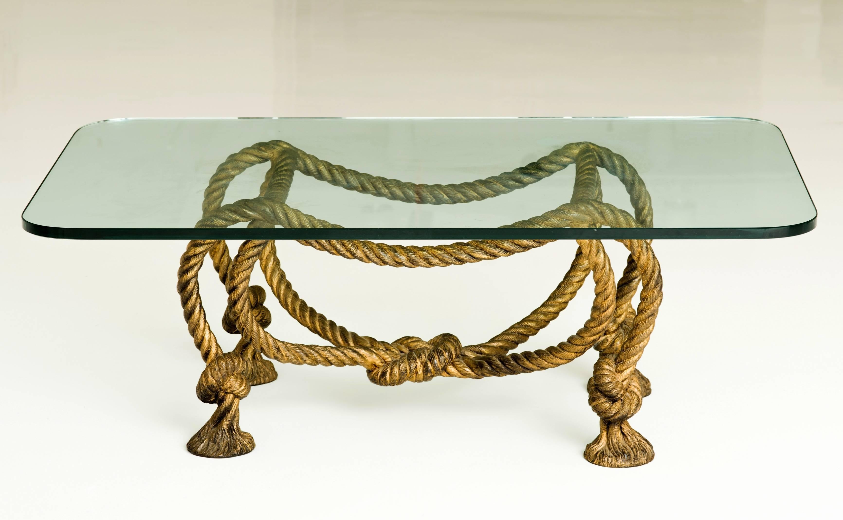 Stunning rope coffee table in the style of Maison Jansen with twisted knots and tassel feet. This gilt metal French or Italian Table with rectangular glass top is beautifully crafted and came from a collection with many Karl Springer originals.