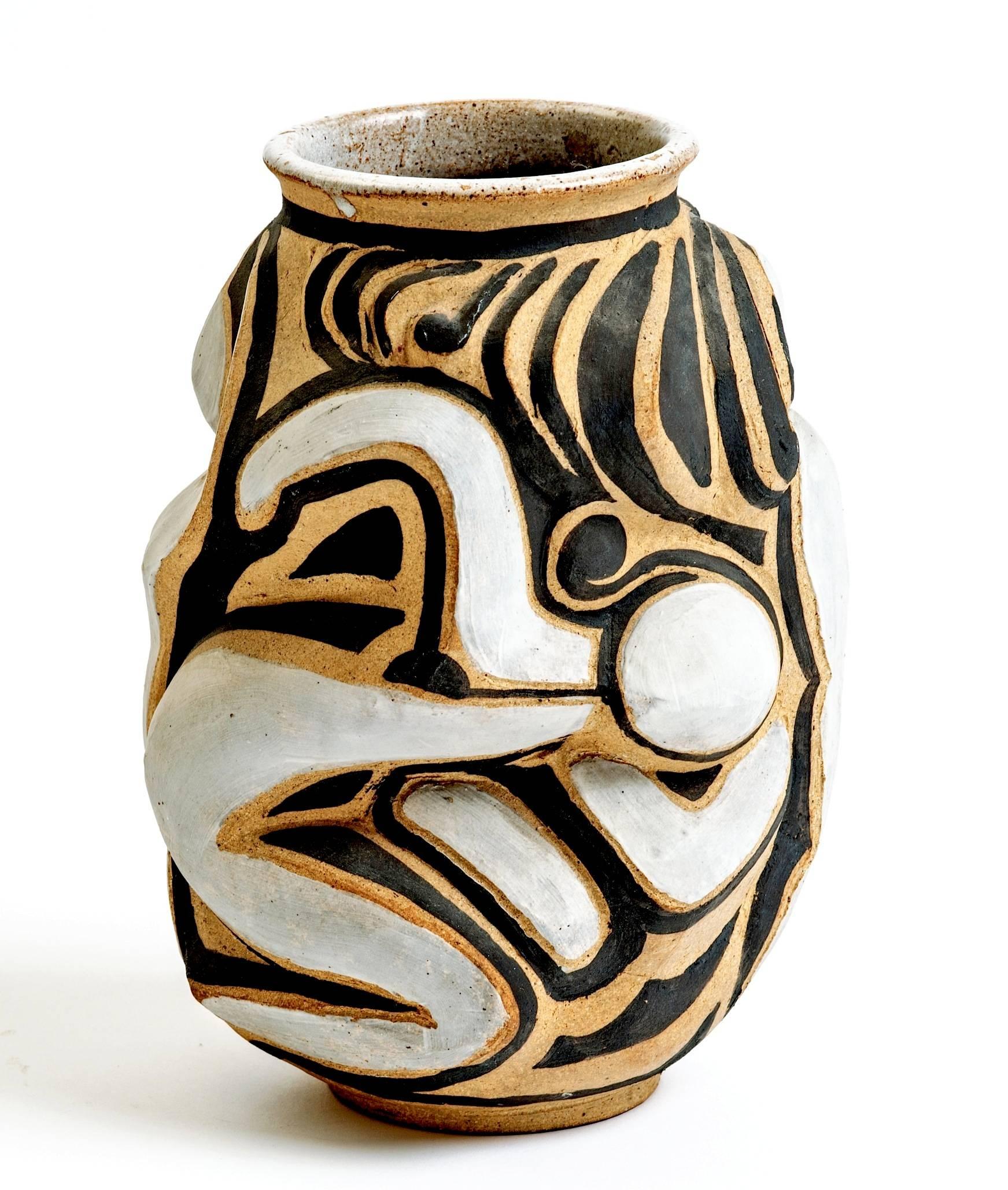 Extra large and quite dynamite this French figural stoneware vase is simply amazing. Multiple carved figures in an incredible scale create this unique sculptural design that has unending movement. Signed.