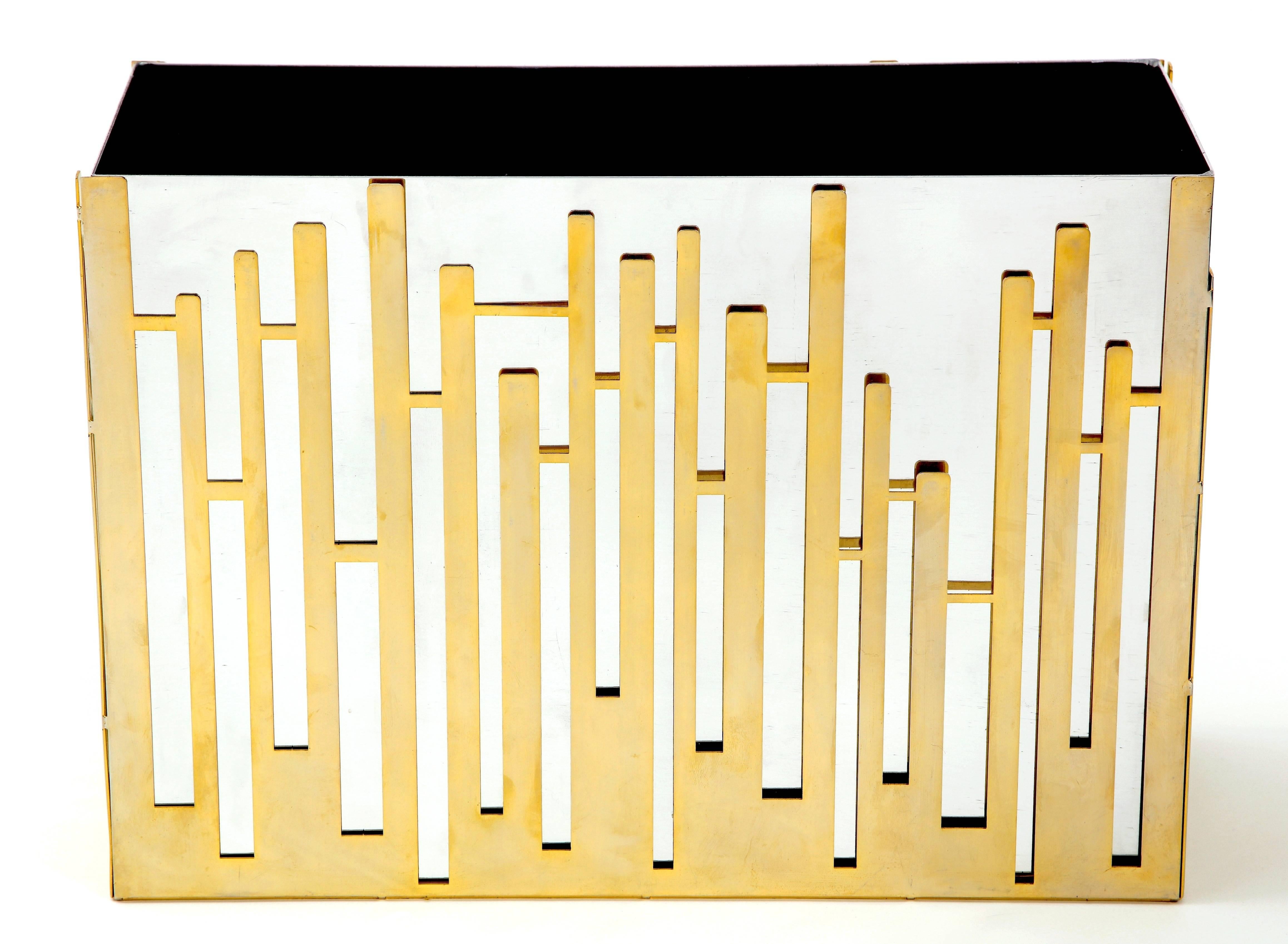 Fabulous and quite unique French magazine rack from the 1970s. Made out of nickel with a geometric abstract brass overlay this piece is sculpturally unique and could double in any room as a sculpture or vase. Very much in the style of Willy Rizzo,