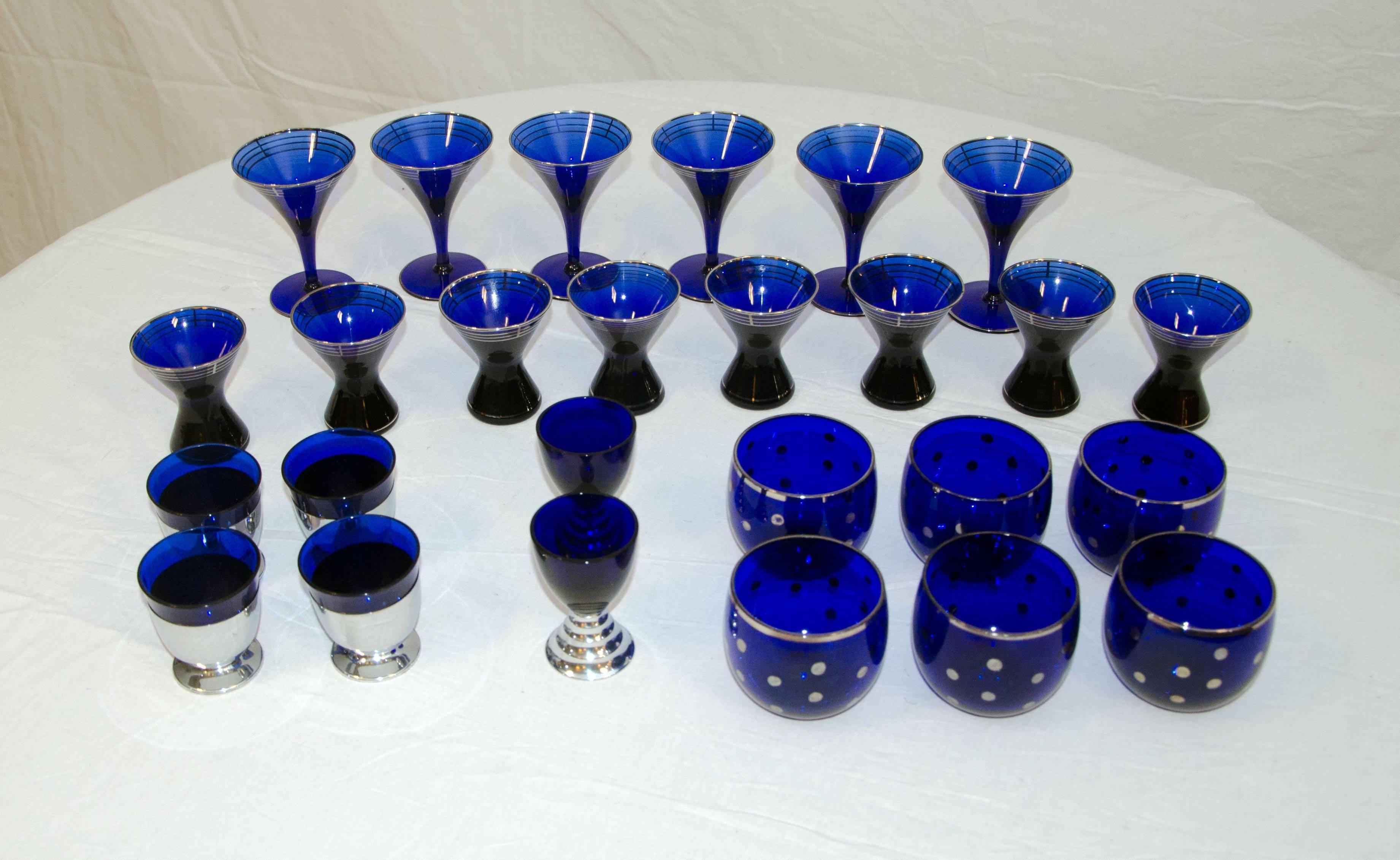 This collection of cobalt blue Art Deco glassware will outfit your cocktail cabinet. There are several different sizes as follows:
Six martini style stemmed glasses accented in silver, 4 1/2