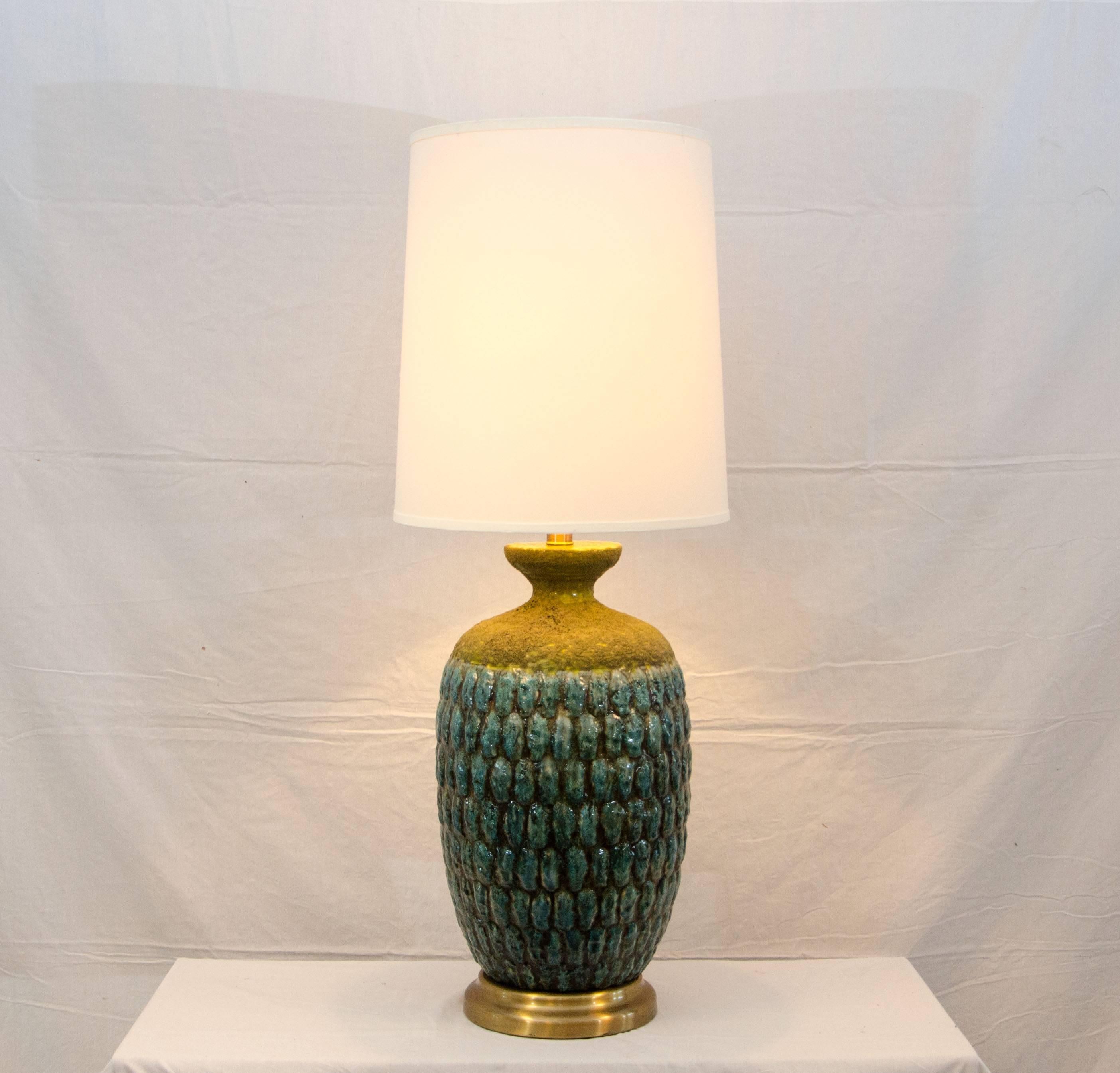 Larger size Studio Pottery table lamp with a new shade. The predominant color is a sea-foam blue with underlying accents of chartreuse. Towards the top part of the base it has a grayish lava style glaze also with underlying chartreuse accents. The