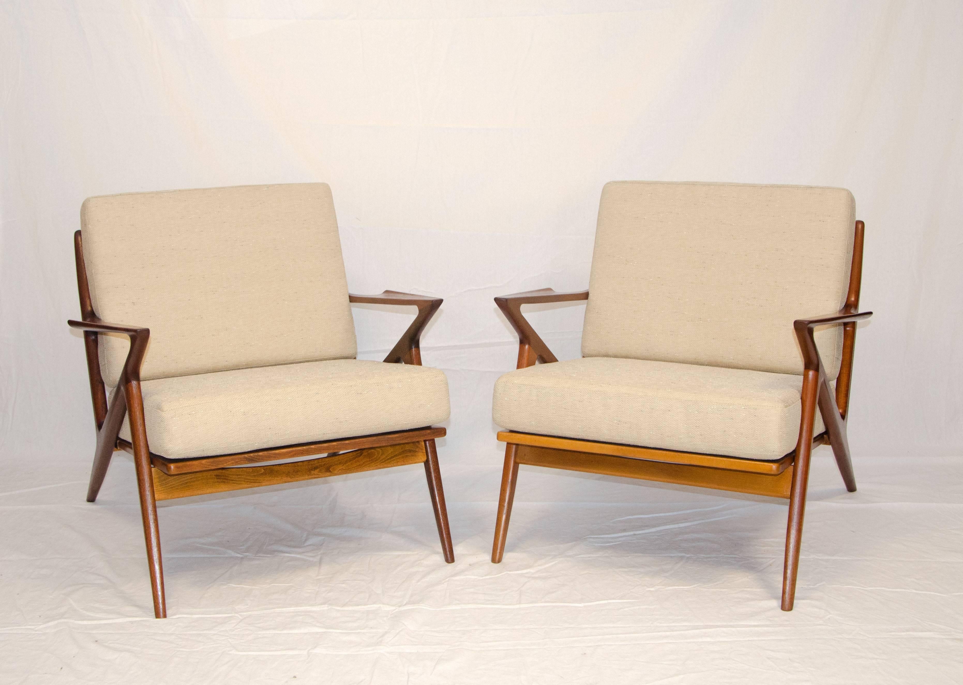 Stylish pair of Danish Z lounge chairs designed by Poul Jensen and manufactured by Selig. These chairs are identical in all ways except for the strapping under the seat cushion. Selig tag only on one chair.
