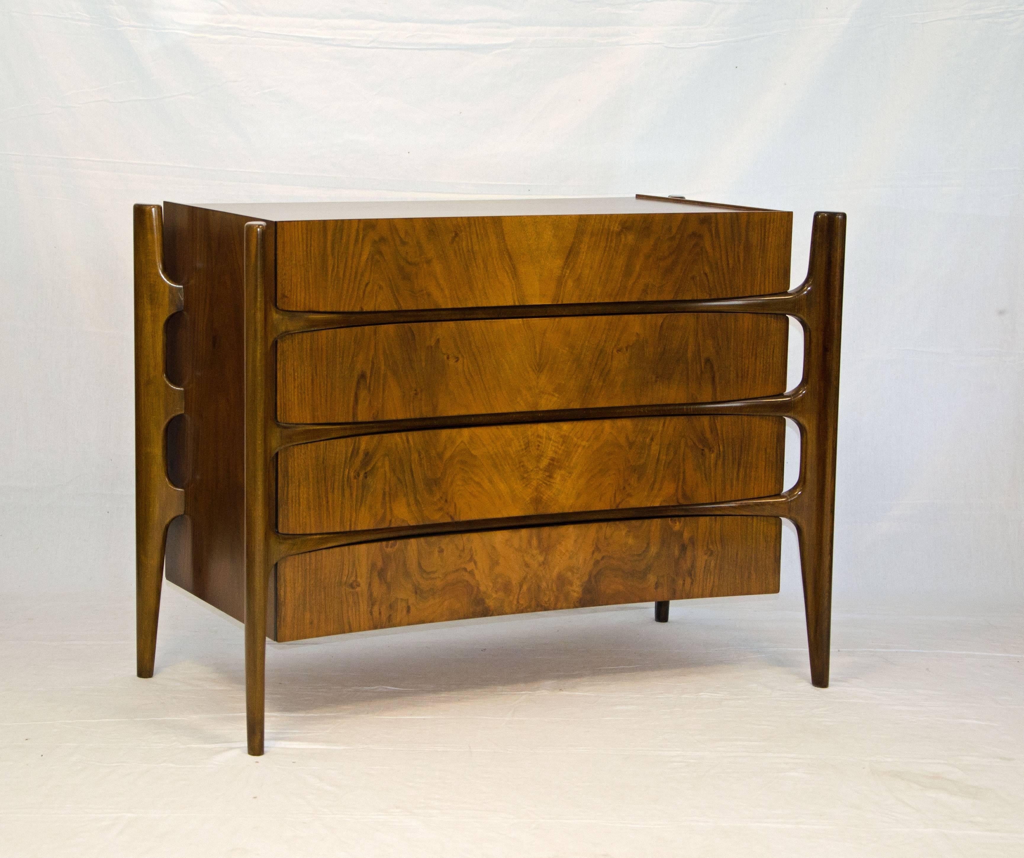 Very unusual dresser designed with an exterior curved framework. Drawer fronts have beautiful bookmatched grain patterns. Made in Sweden by The Swedish Furniture Guild for Urban Furniture, circa 1950. Often mis-attributed to Edmond Spence.