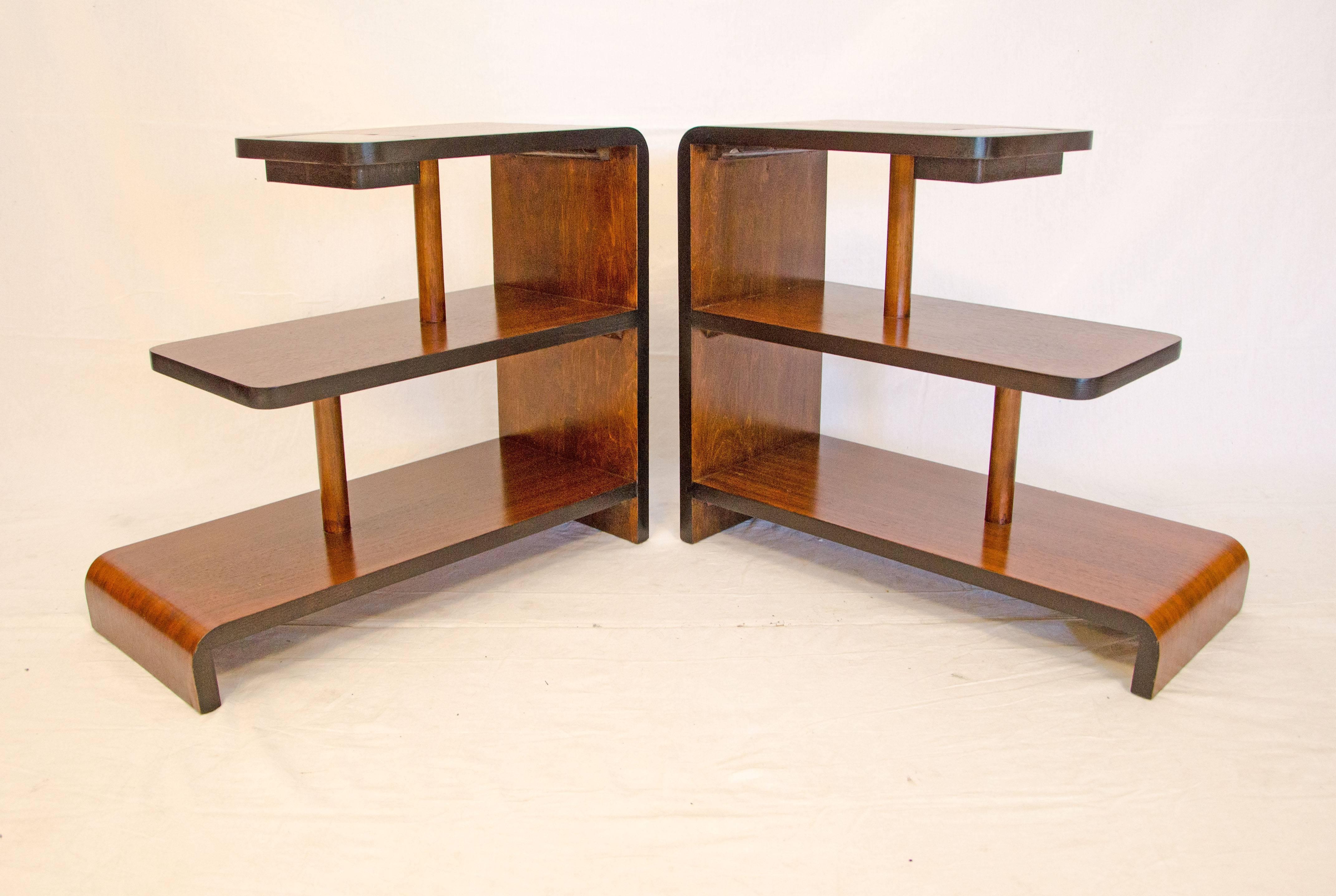 Very nice smaller scale end tables consisting of three graduated sized levels 15 3/4", 20", 24" long. The top has a small divided tray covered by a removable piece of black glass. The edges of the tables are accented by the black as