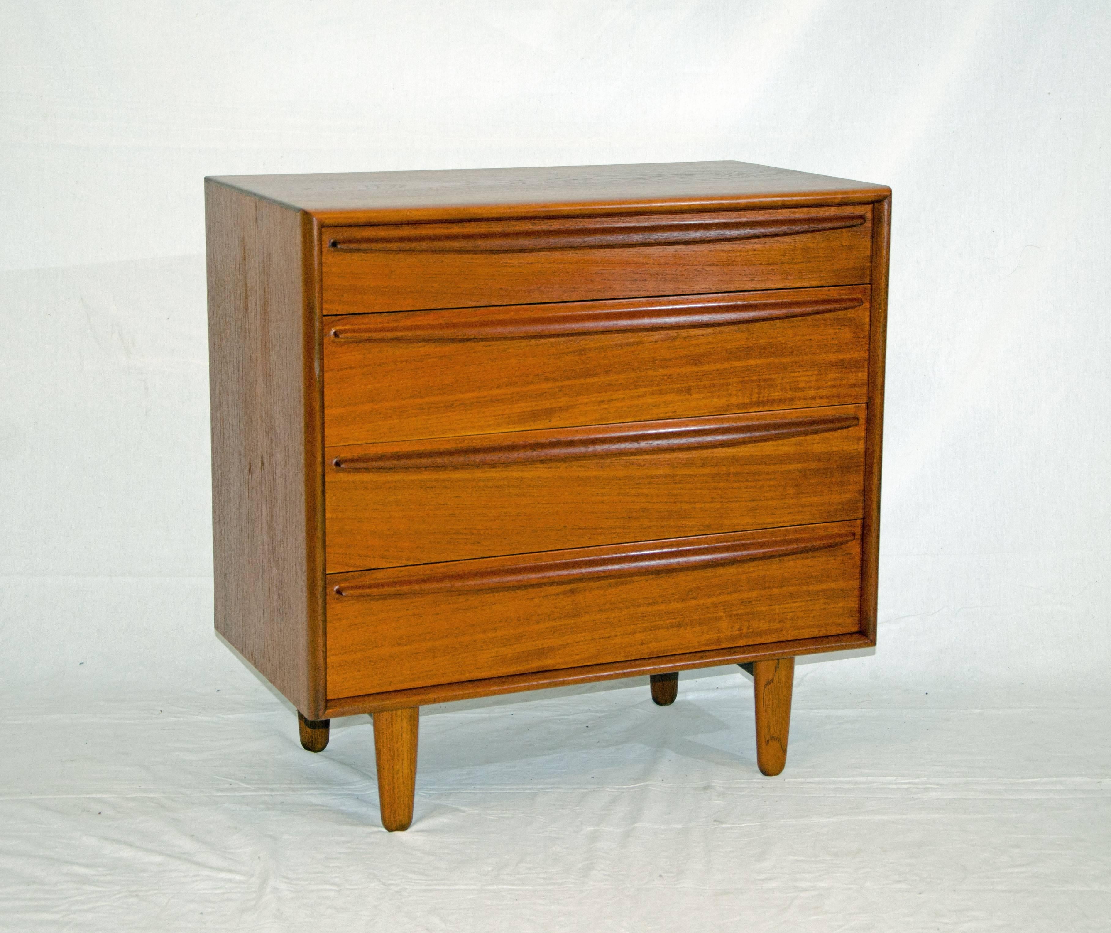 Nice small four-drawer teak chest perfect for a child's room or hallway. It is a well made small dresser with mahogany drawer bottoms and sides. The top drawer is 3 1/2