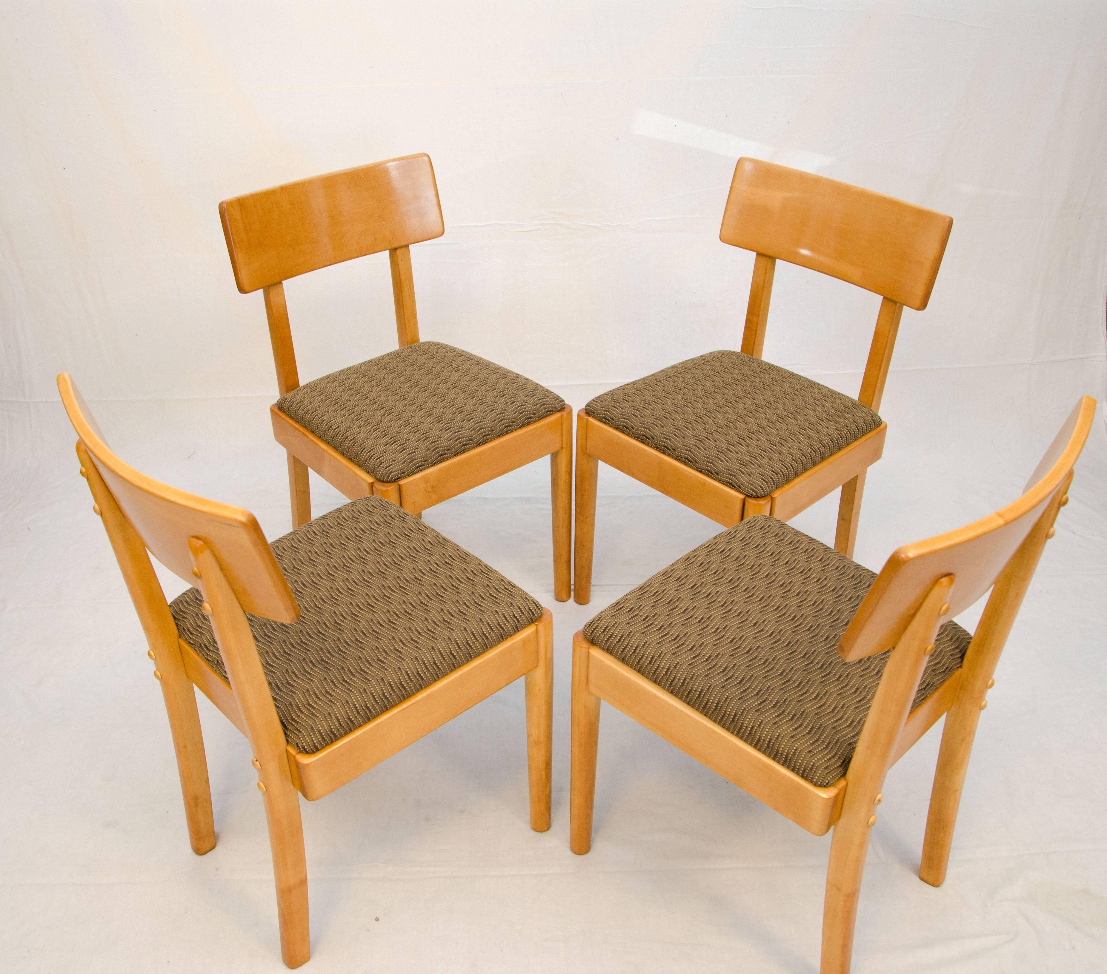 Solid maple set of four dining chairs designed by Russel Wright for his early Young American Modern line. Manufactured by Conant Ball model 3602