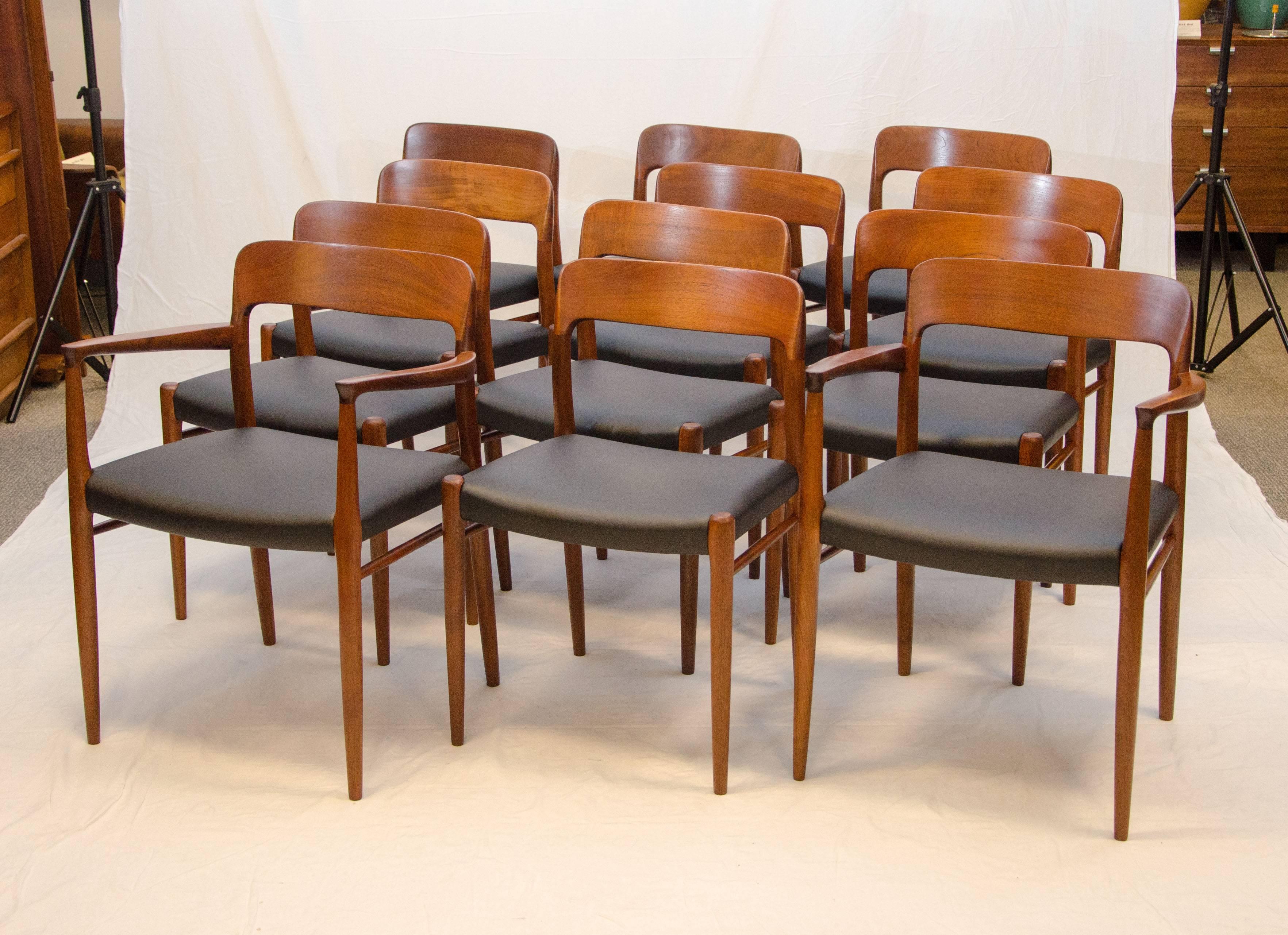 Large set of solid teak Danish dining chairs consisting of two model #56 armchairs and ten model #75 side chairs. The stretchers between the front legs and back allow for extra strength. Seats have been re-upholstered with low maintenance high