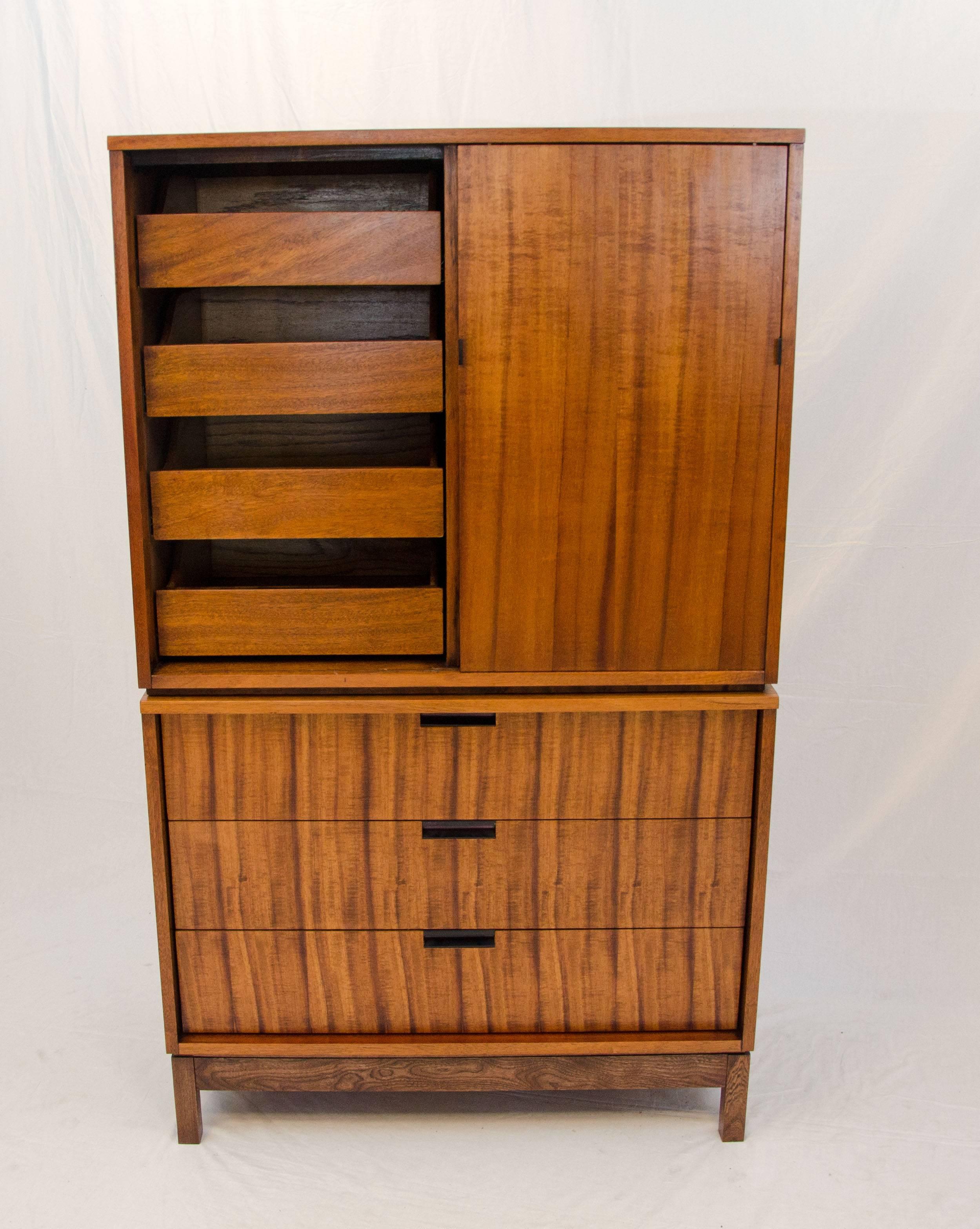 Unusual chest on chest with lots of storage space. Drawer fronts and sliding door display book-matched active grain patterns. Four interior drawers are also accessible by sliding door to the right. All drawers slide in and out easily. Drawers have