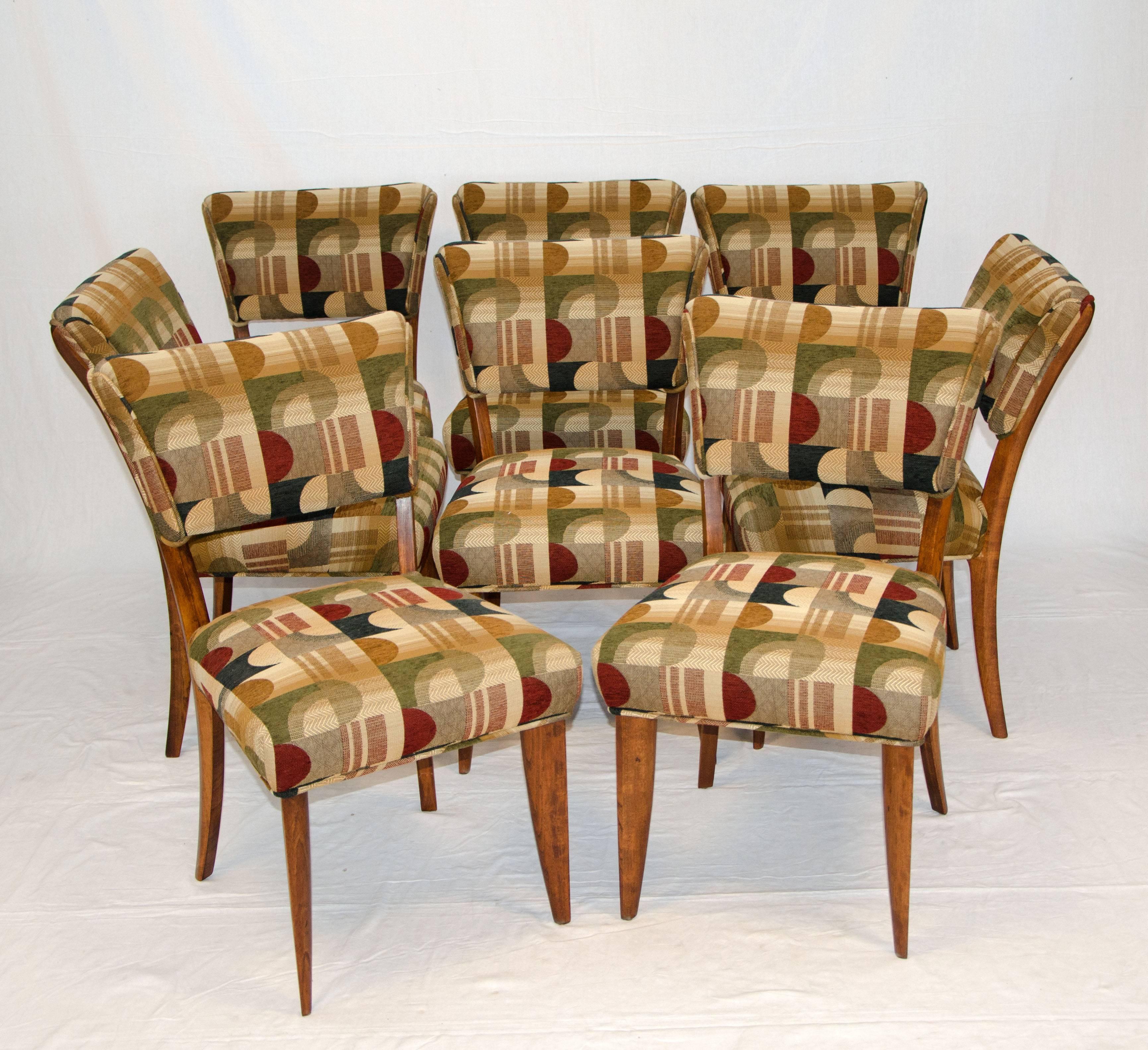 Nice set of eight dining chairs with upholstered backs and seats. The chair backs are somewhat canted to allow for a comfortable seating position. The front legs are very angular and tapered, they give a "flat" appearance but are about