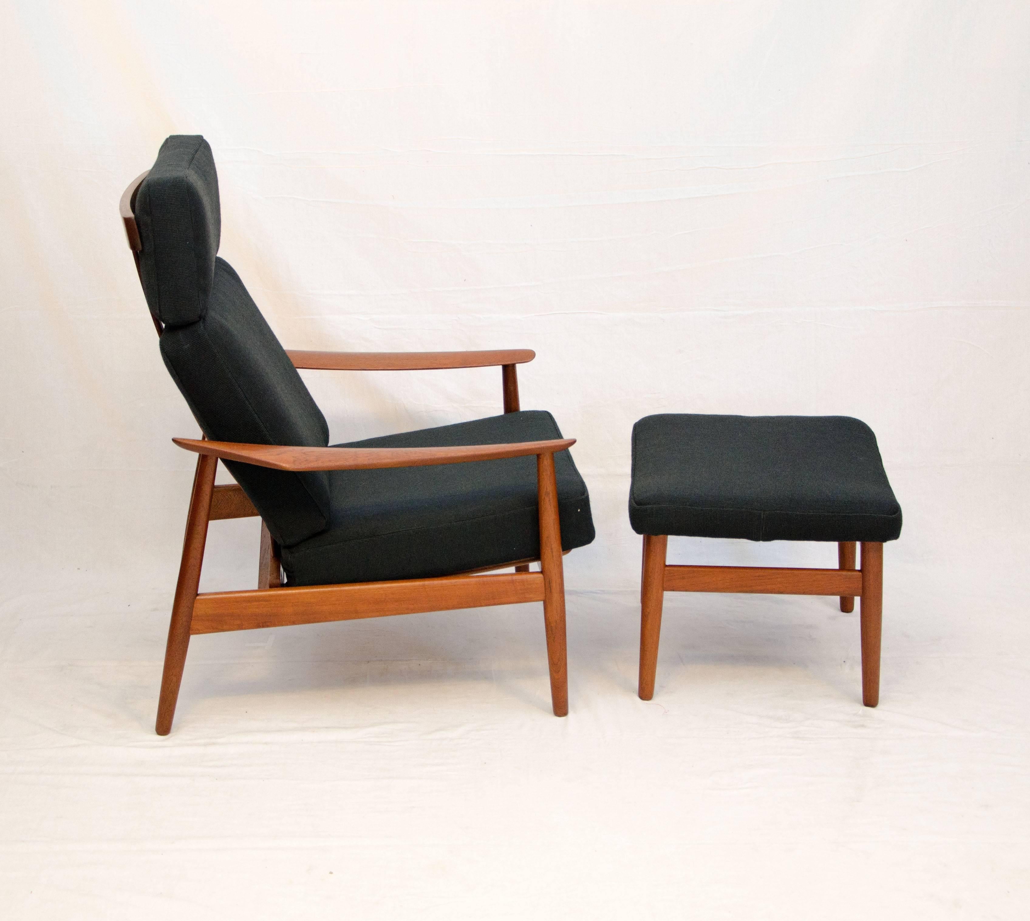 Very comfortable three position high back Danish teak reclining lounge chair with matching ottoman. Both retain the original France & Sons circular tags. The reclining positions require manual adjustment. The fabric is a durable nubby black gross