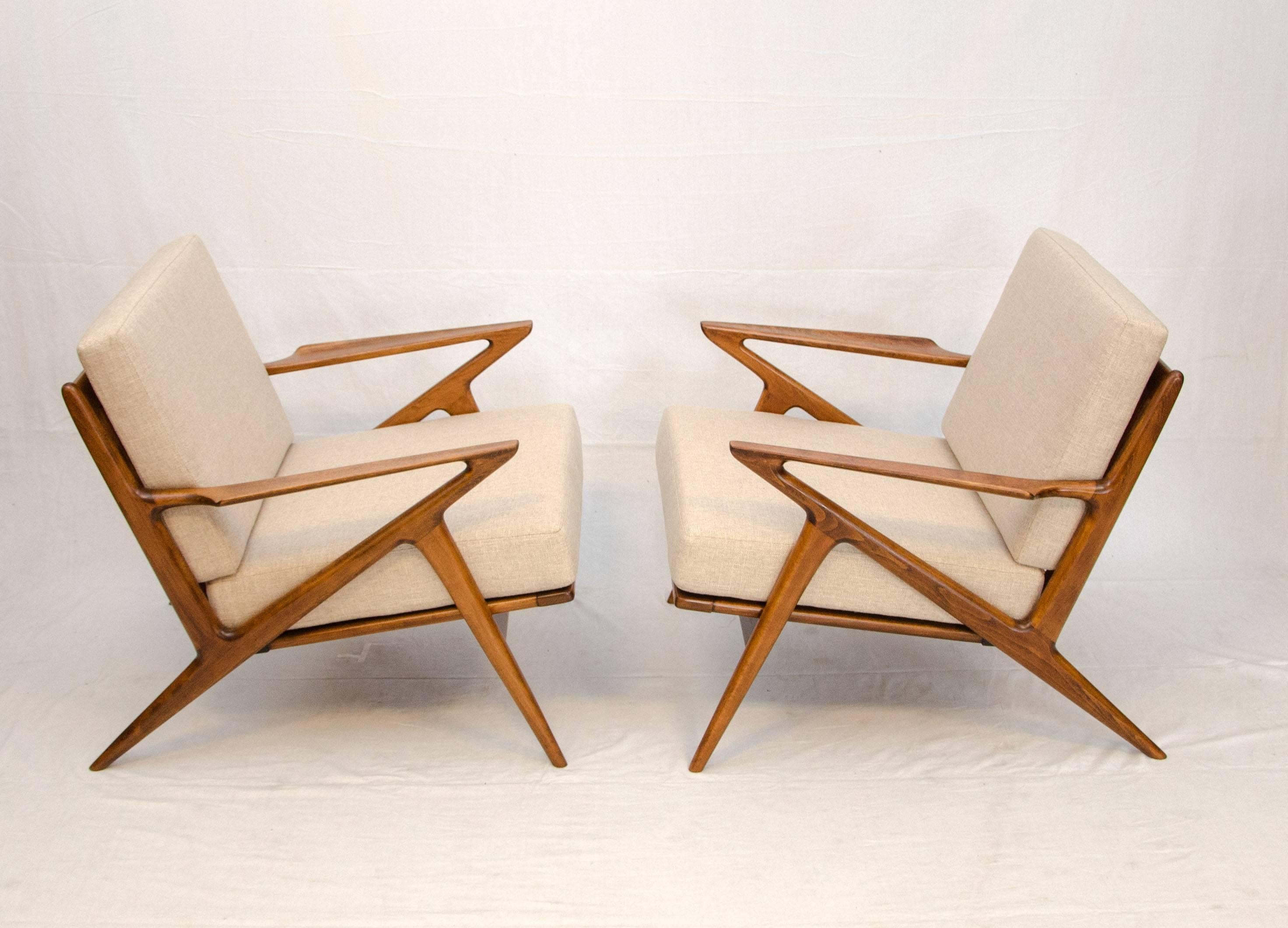 Popular iconic Danish "Z" lounge chairs designed by Poul Jensen for Selig. Both chairs retain the circular red and white Selig labels on the seats. The arms have the signature upturned edges, the chair design is very angular. The seat