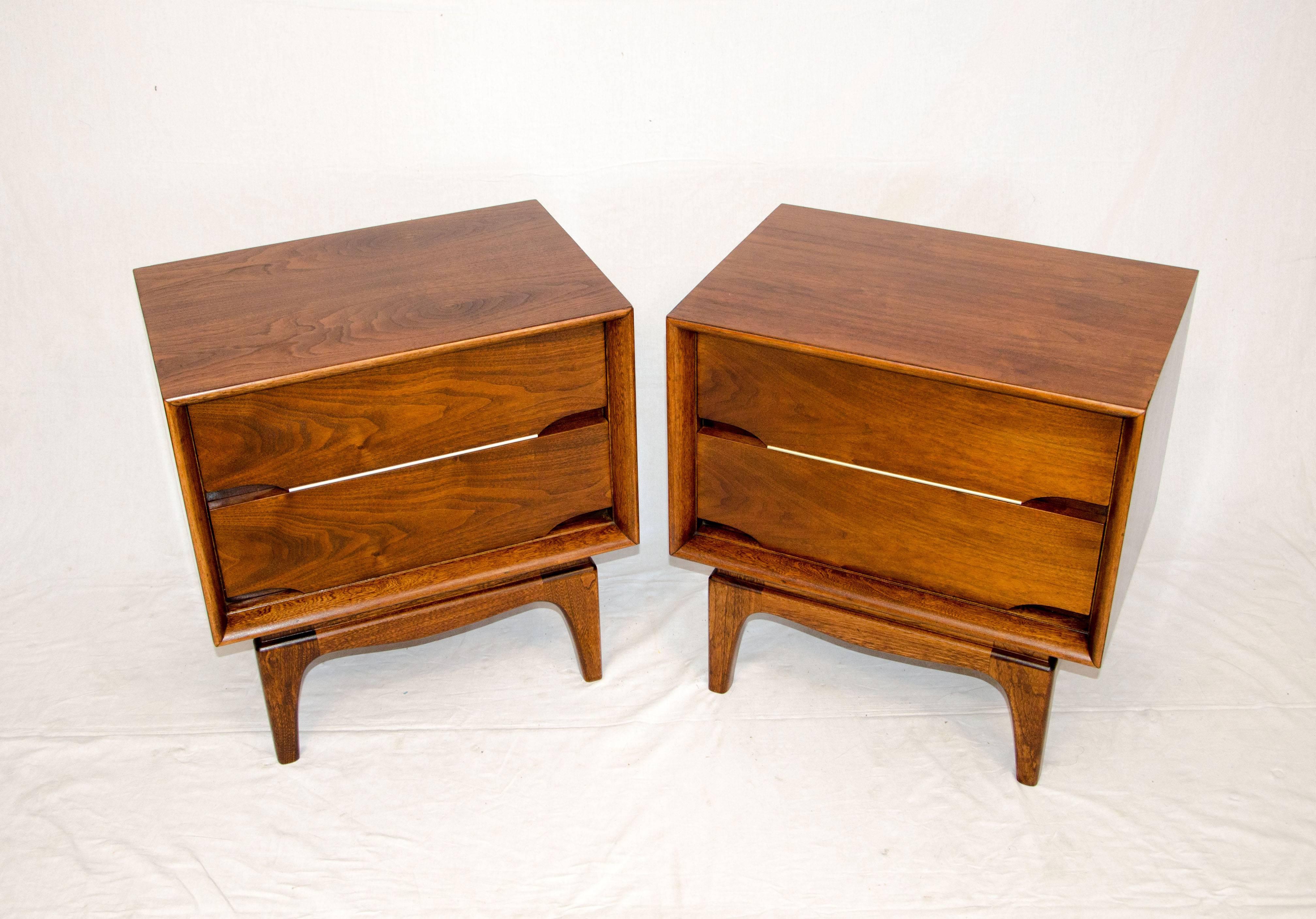 Pair of Mid-Century walnut nightstands with two drawers. The base is 9 1/2