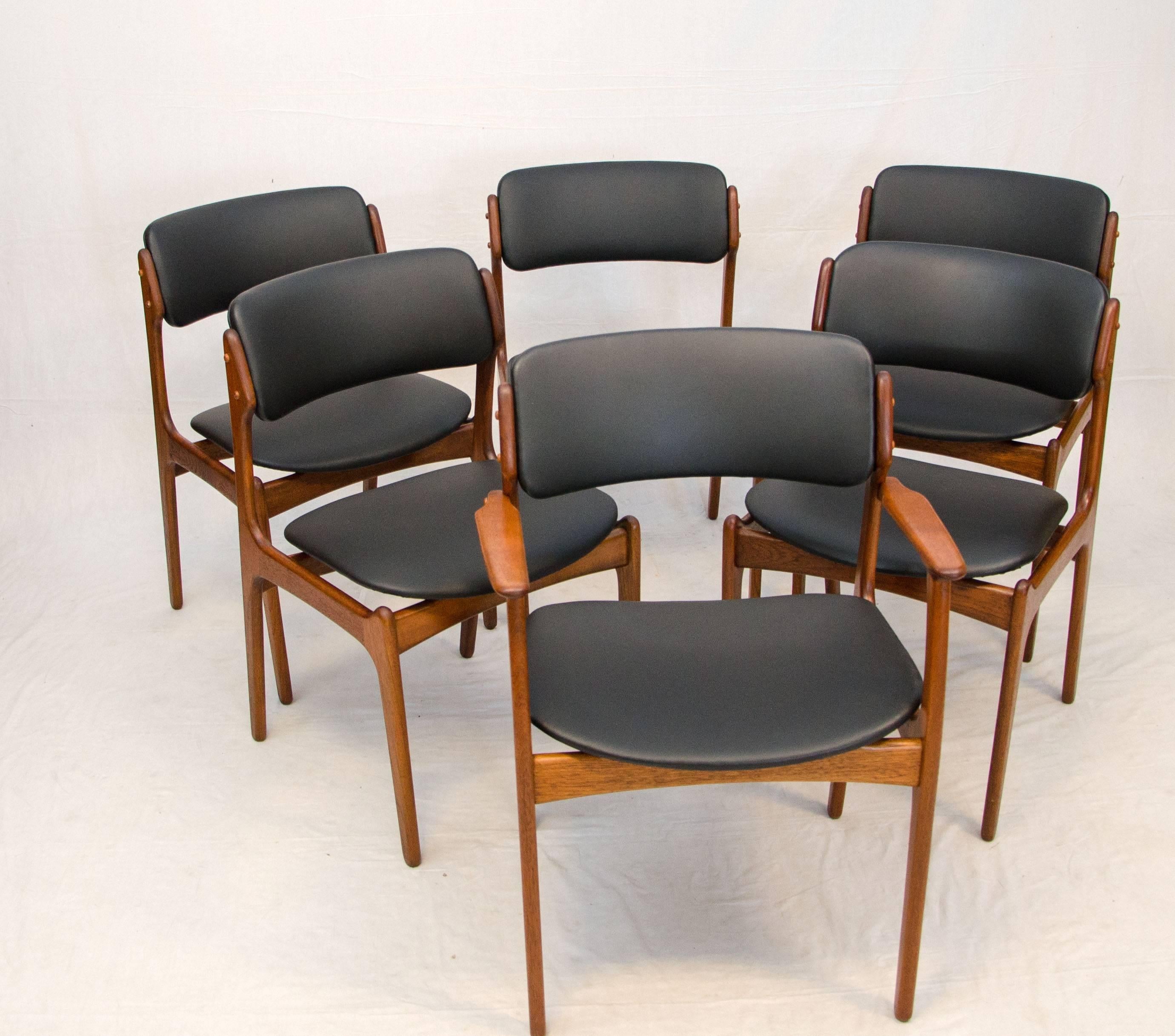 Nice set of six Danish teak dining chairs designed by Erik Buck and manufactured by O. D. Møbler. The chairs are very comfortable with an upholstered back and a floating seat. Chairs have new faux leather upholstery, as was original, faux leather is