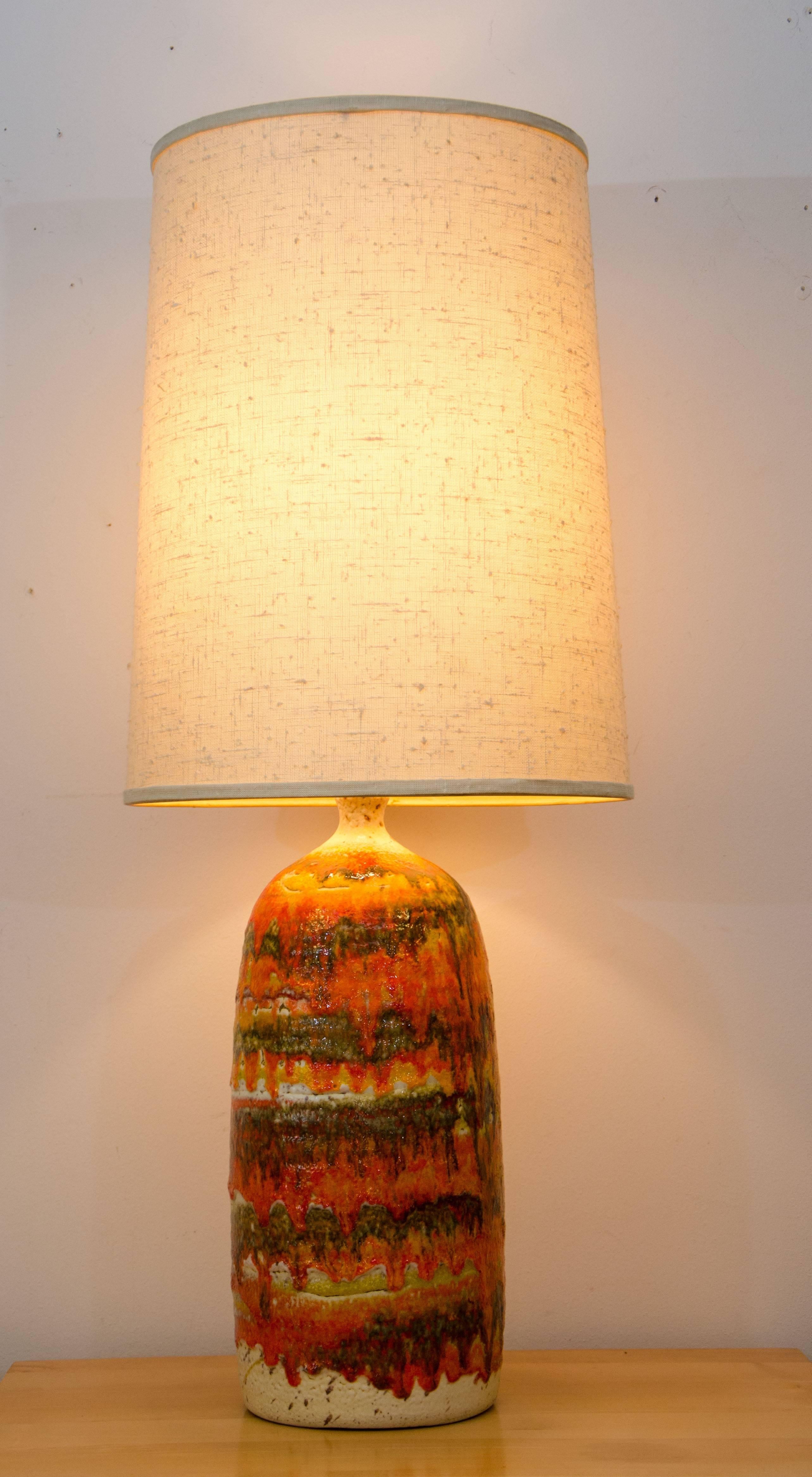 Beautiful Studio Pottery table lamp exhibiting shades of off-white, orange, yellow, and green with a textured drip glaze effect. The original shade is the perfect size and is also textured.
The shade is 18 1 / 4
