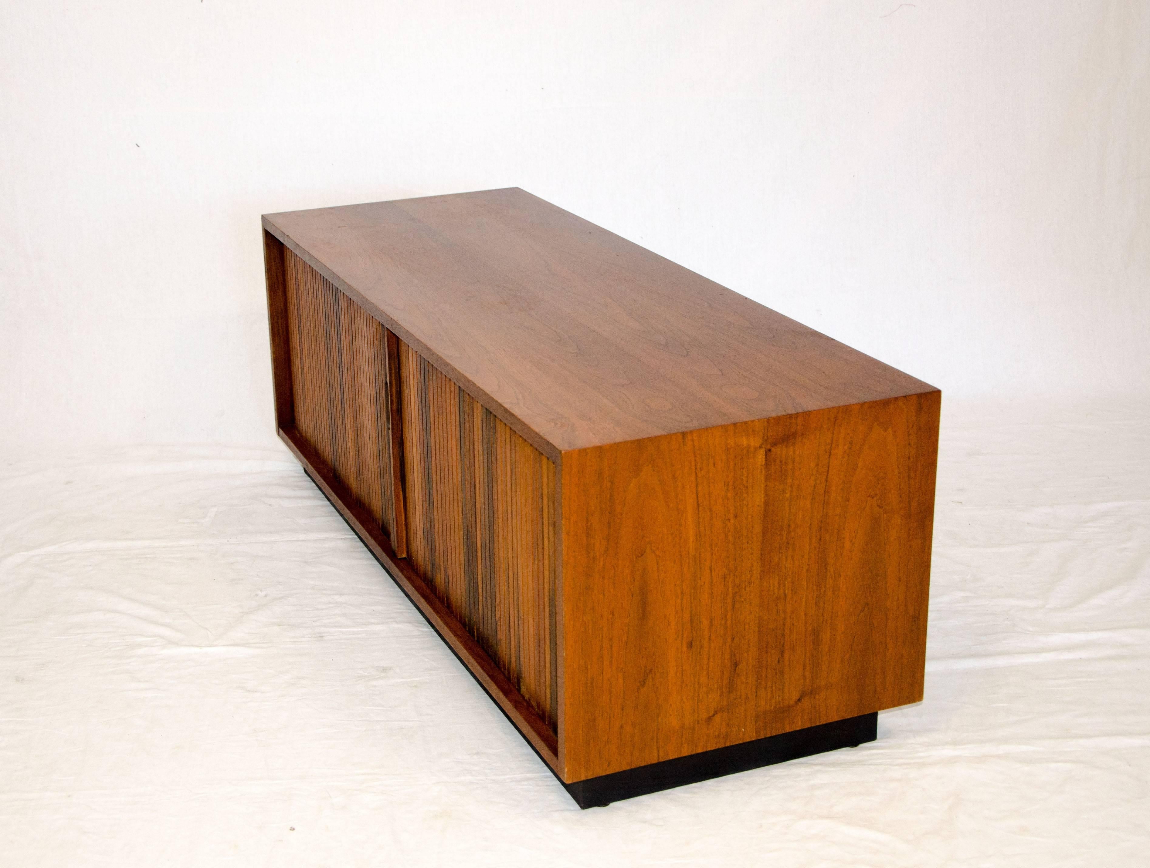 Low walnut cabinet made for record storage but also would be good for a flat screen stand as well as a bench with a cushion on top. The cabinet is on a plinth base which is removable if stainless or hairpin legs are installed for increased height.