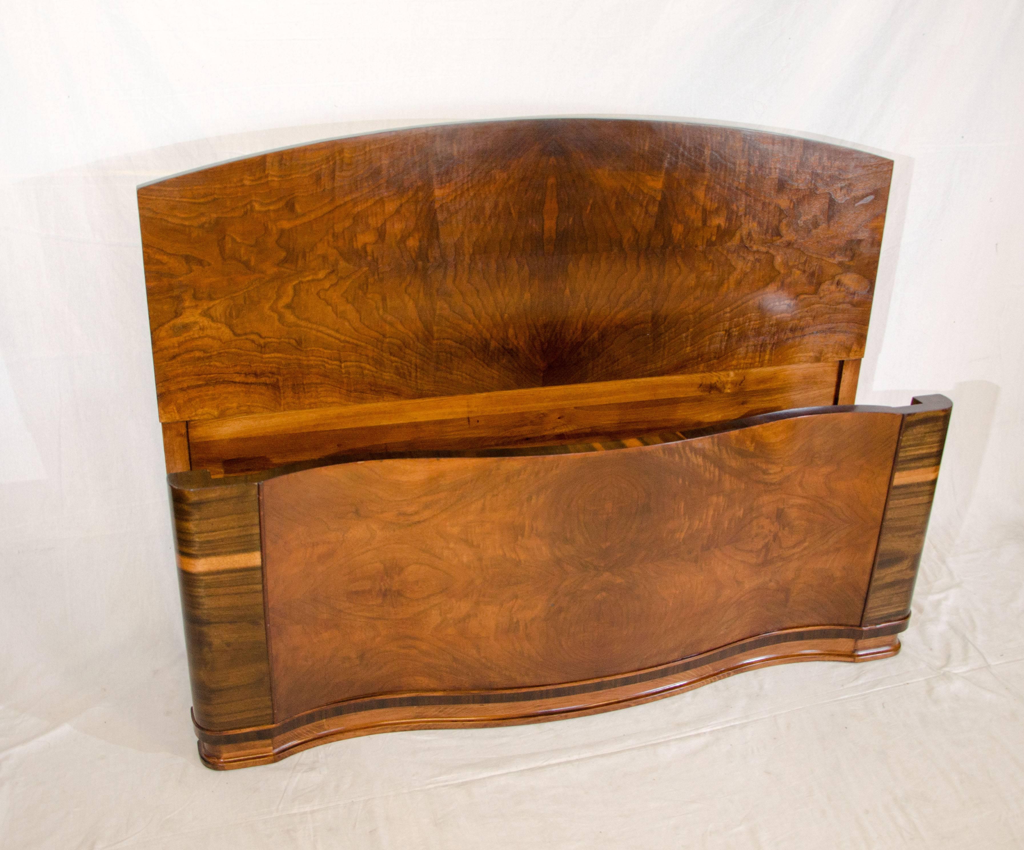  Very nice Art Deco walnut double bed frame with wooden side rails. Both the headboard and footboard are book-matched burl walnut. The headboard is arched and the footboard is serpentine. The bed will accommodate a standard full size mattress and a